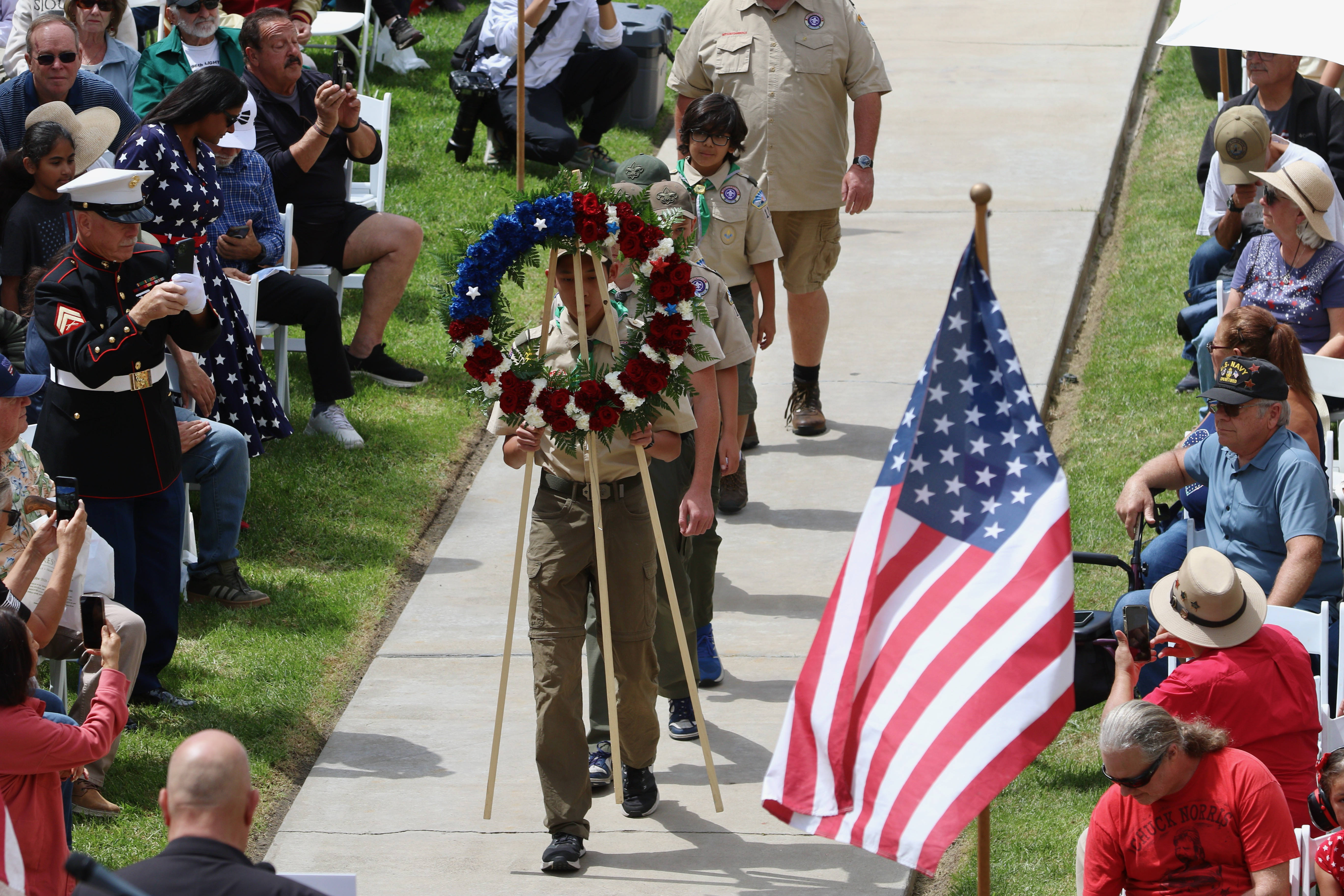 Scout Troop 120 presents a wreath in honor of members...