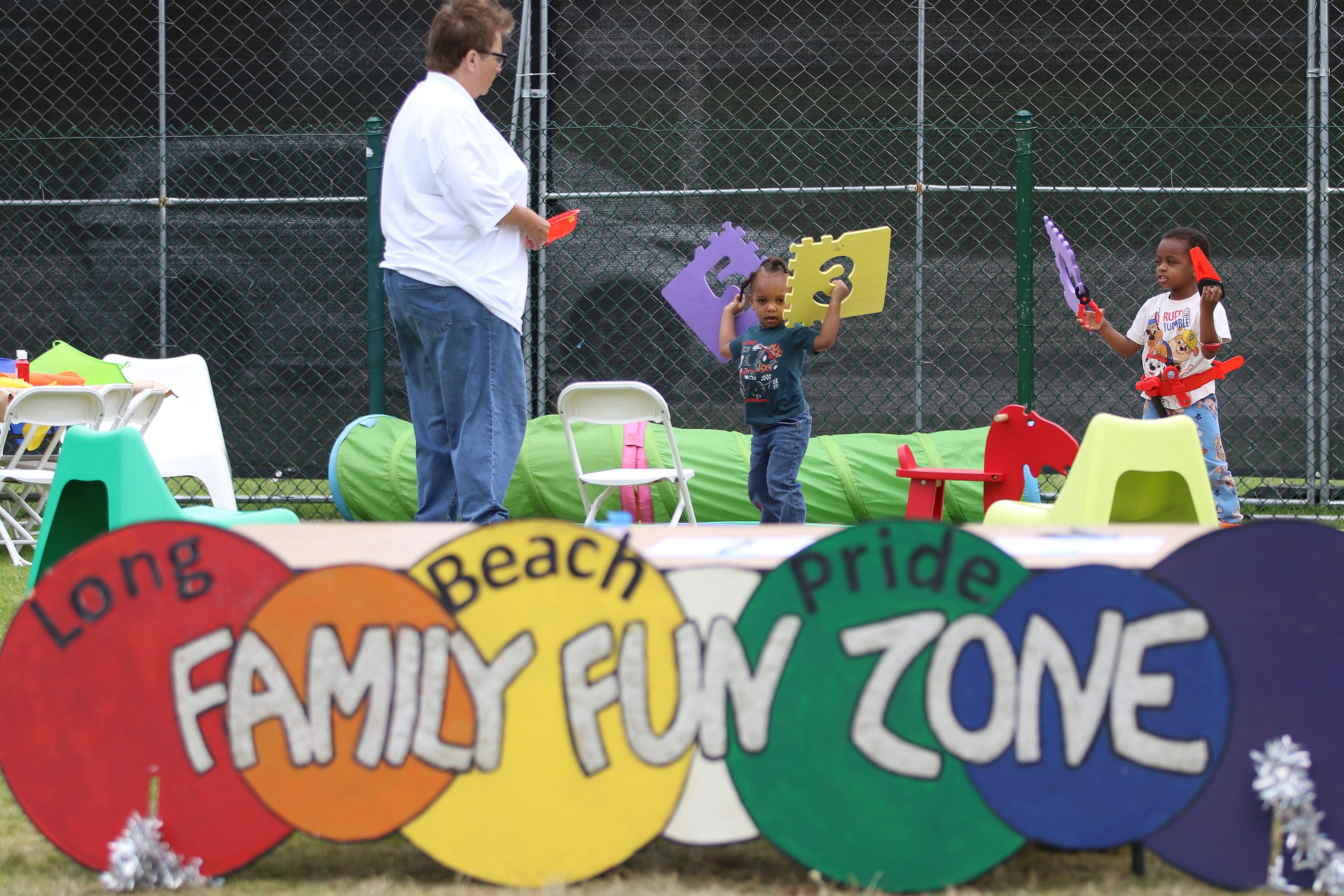 Youngsters play in a family area at the Long Beach...