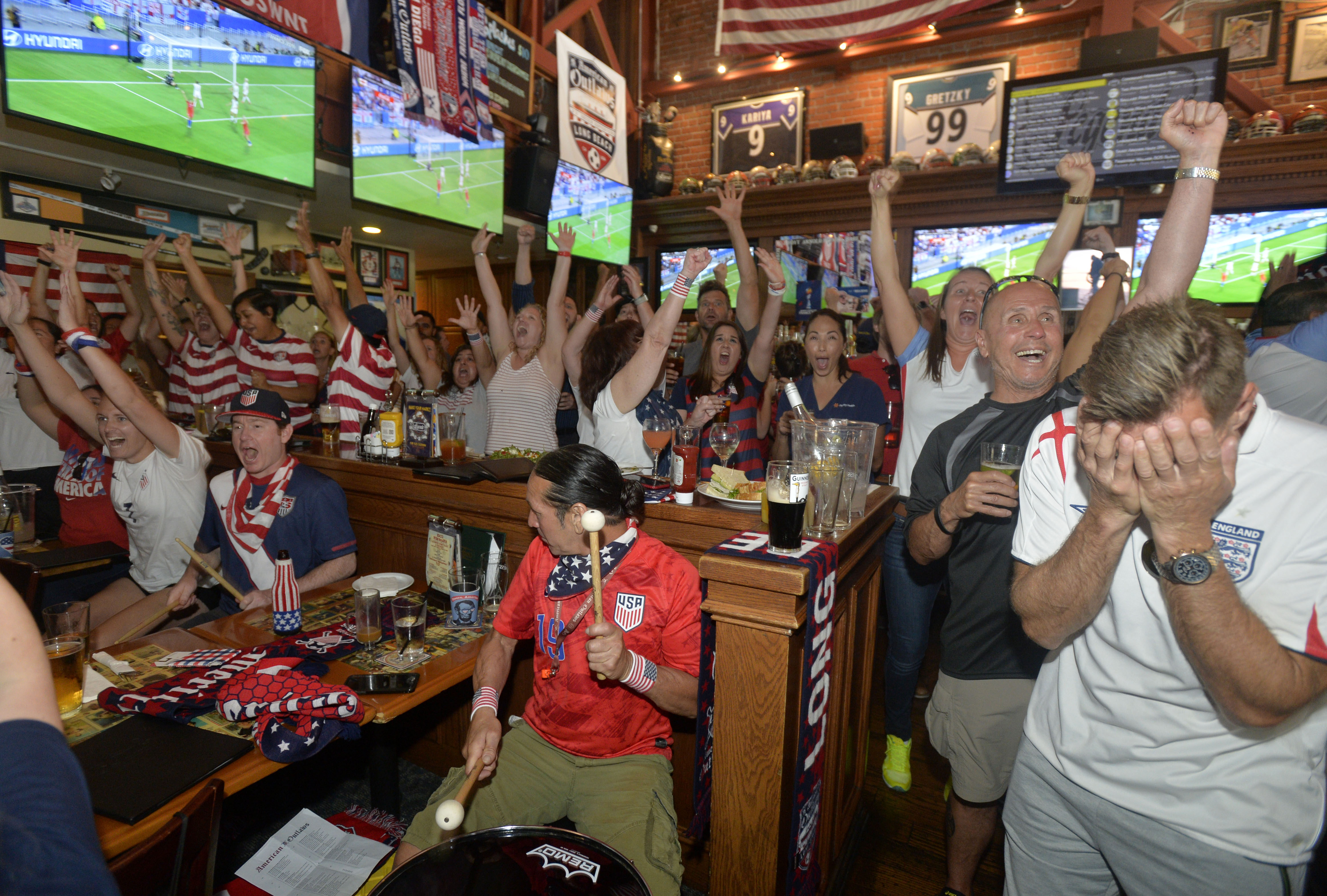 The crowd inside Legends Restaurant and Sports Bar, erupts in...