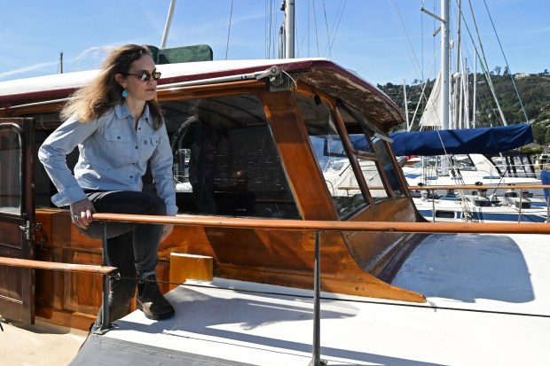 Lauren de Remer walks on her boat at Pelican Harbour in Sausalito, Calif. on Monday, May 11, 2026. (Alan Dep/Marin Independent Journal)