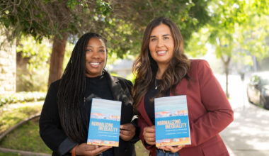 Two women in professional attire, one Black and one Latina, hold up copies of a book with the title Normalizing Inequality.