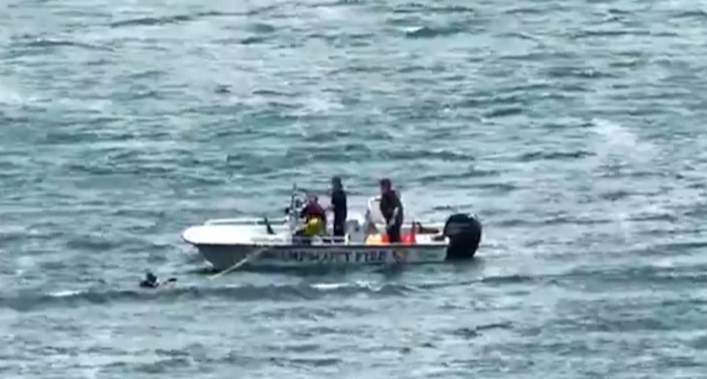 First responders worked together to rescue a kite boarder in distress off Nahant's Long Beach Wednesday afternoon.