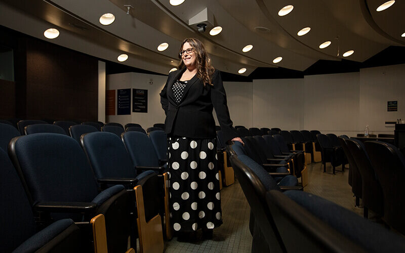Sociology and philosophy grad Nichole Gideon poses in classroom