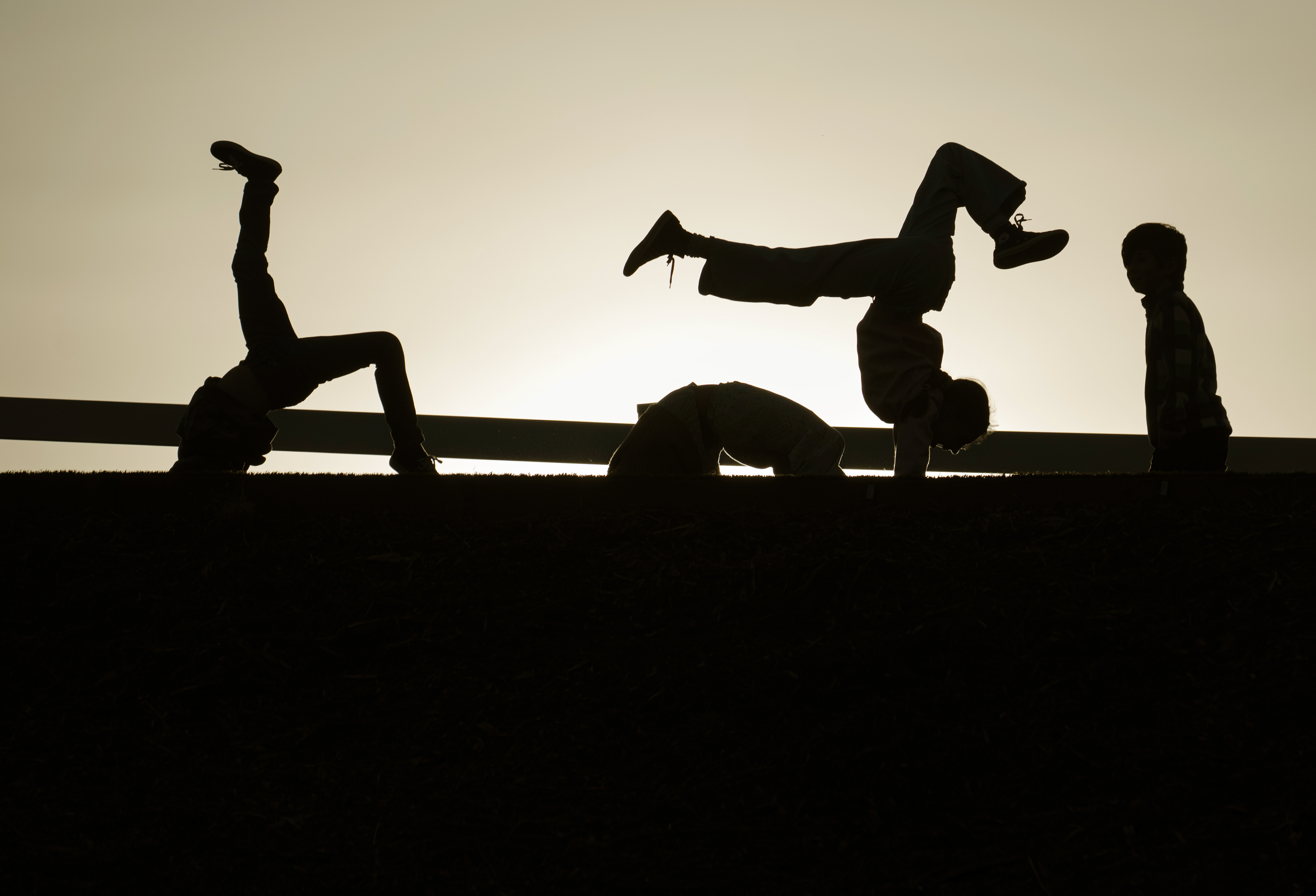 Gilrs do early morning calisthenics as the sun rides over...