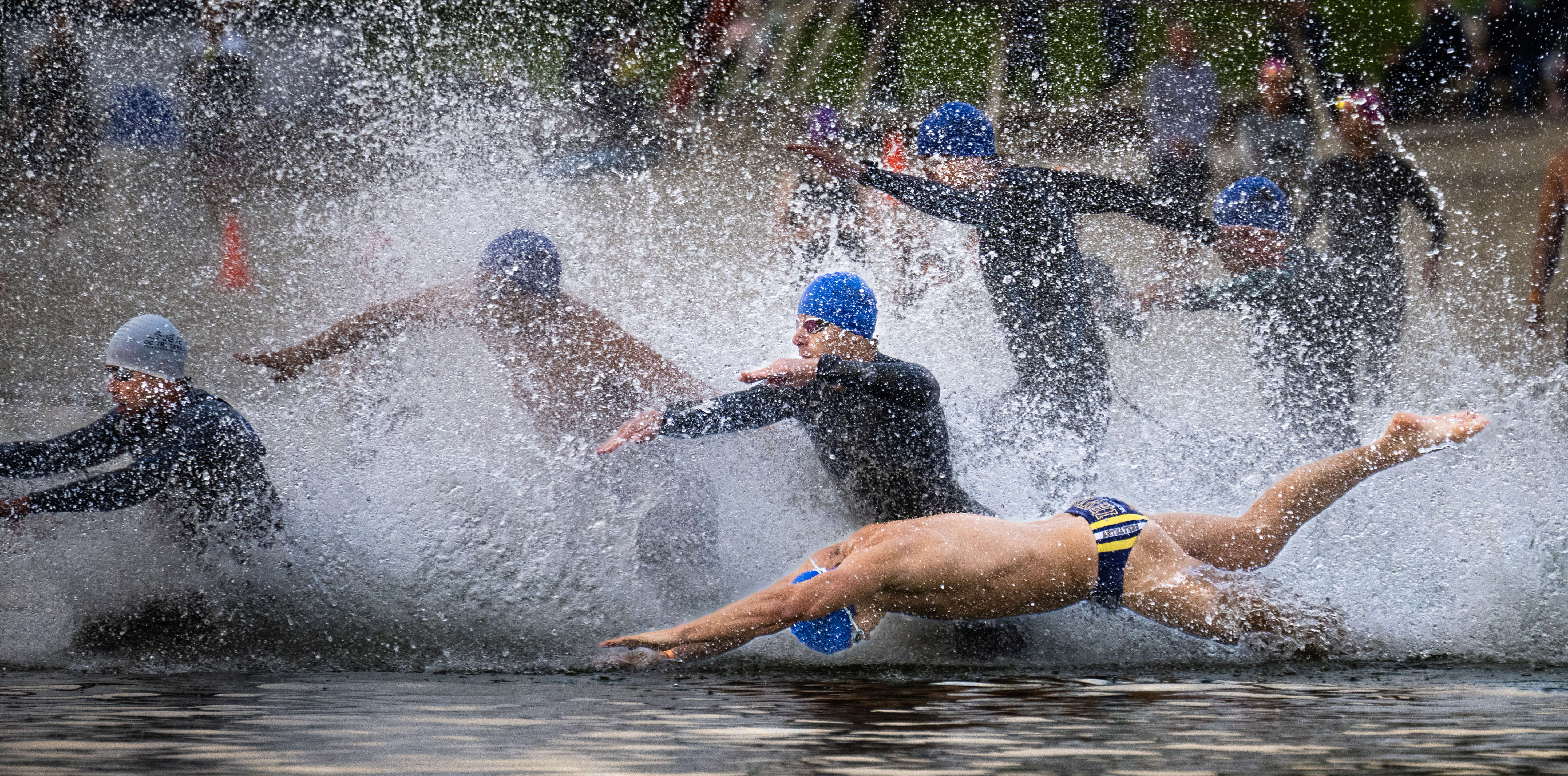 Male athletes hit the water during the OC Tri Series...