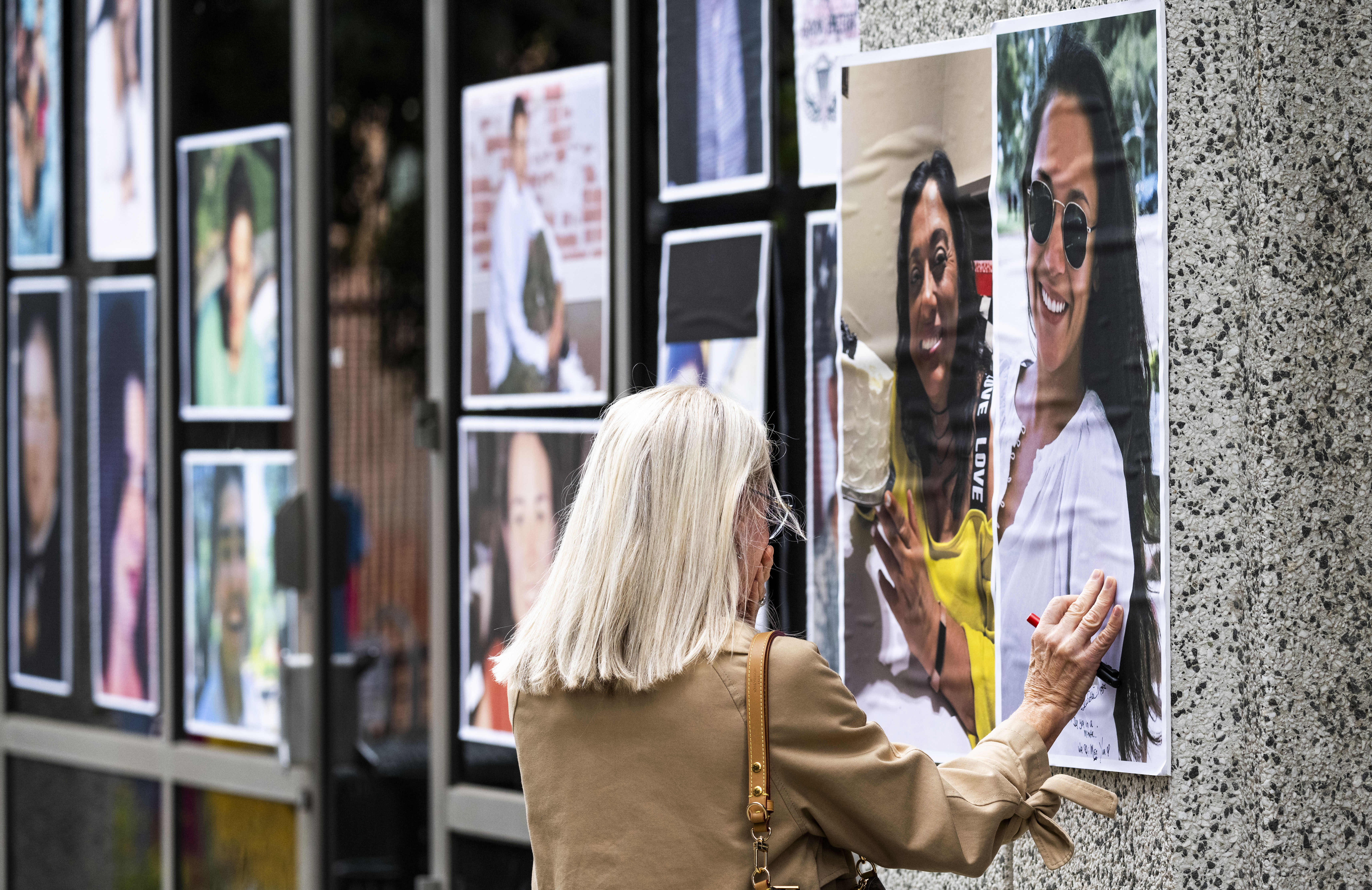 Elizabeth Glenn pauses at a photo of her daughter, Amy...