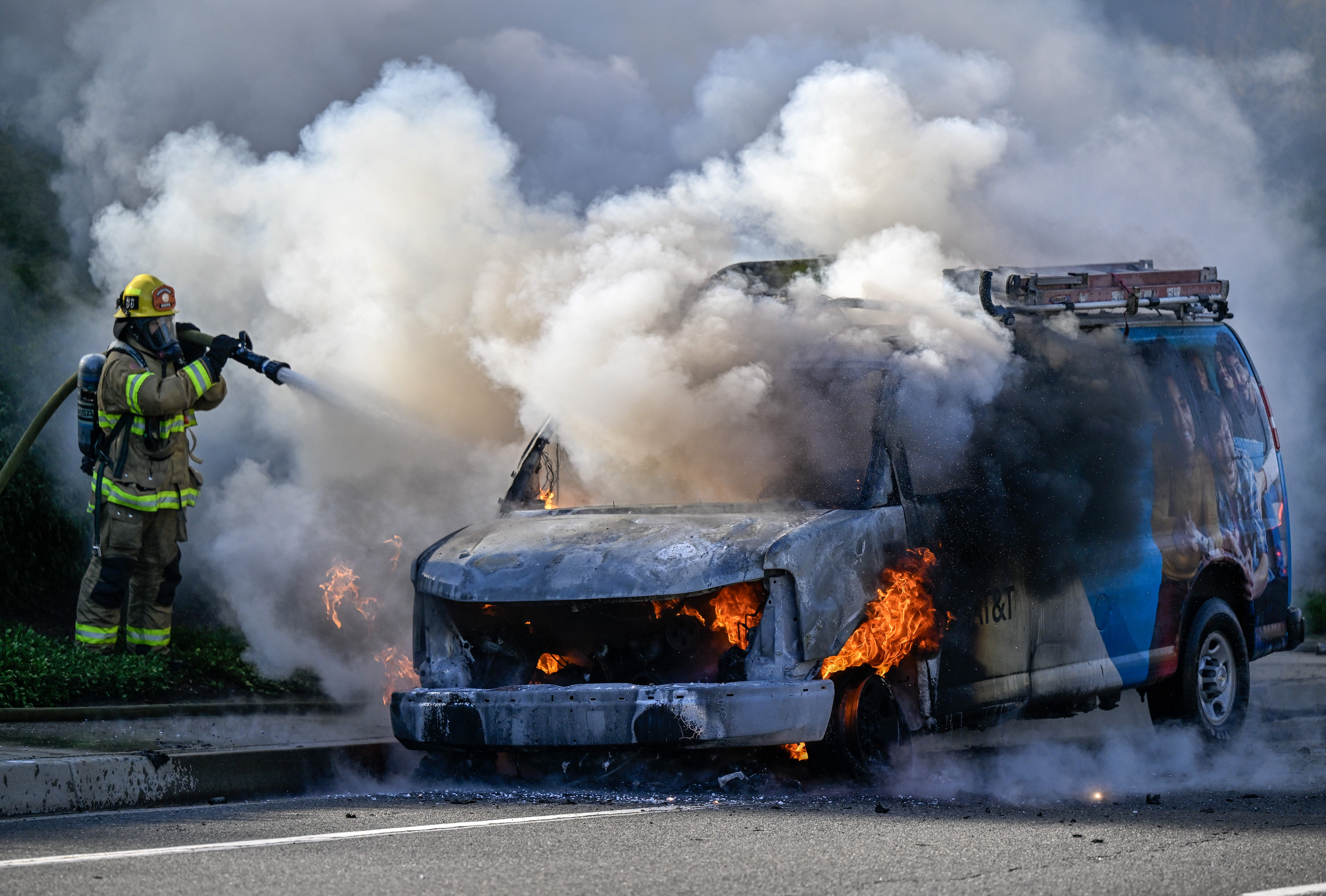 Orange County Fire Authority firefighters respond to a vehicle fire,...