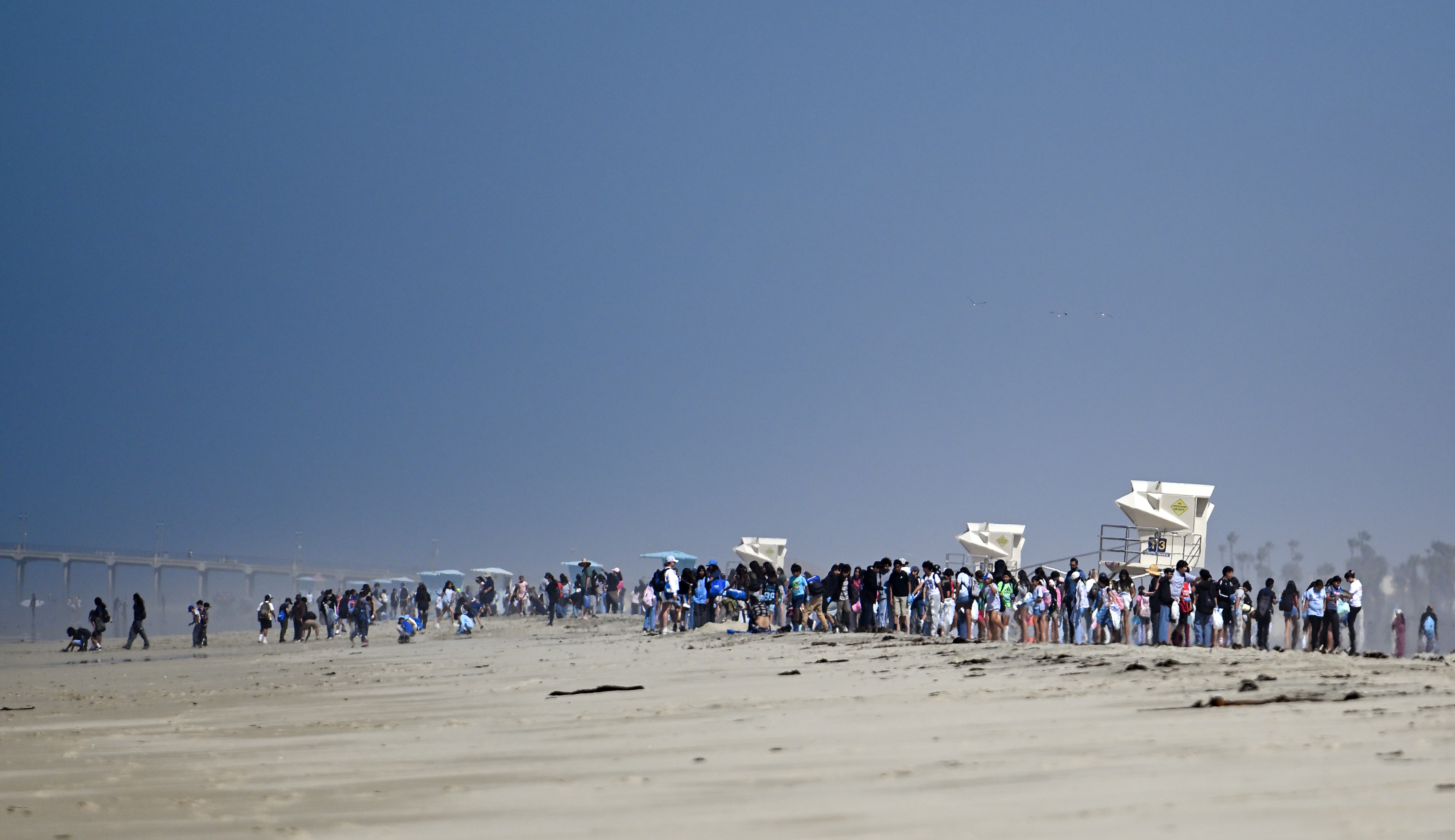 Students shower the beach for trash during Orange County Coastkeeperâs...