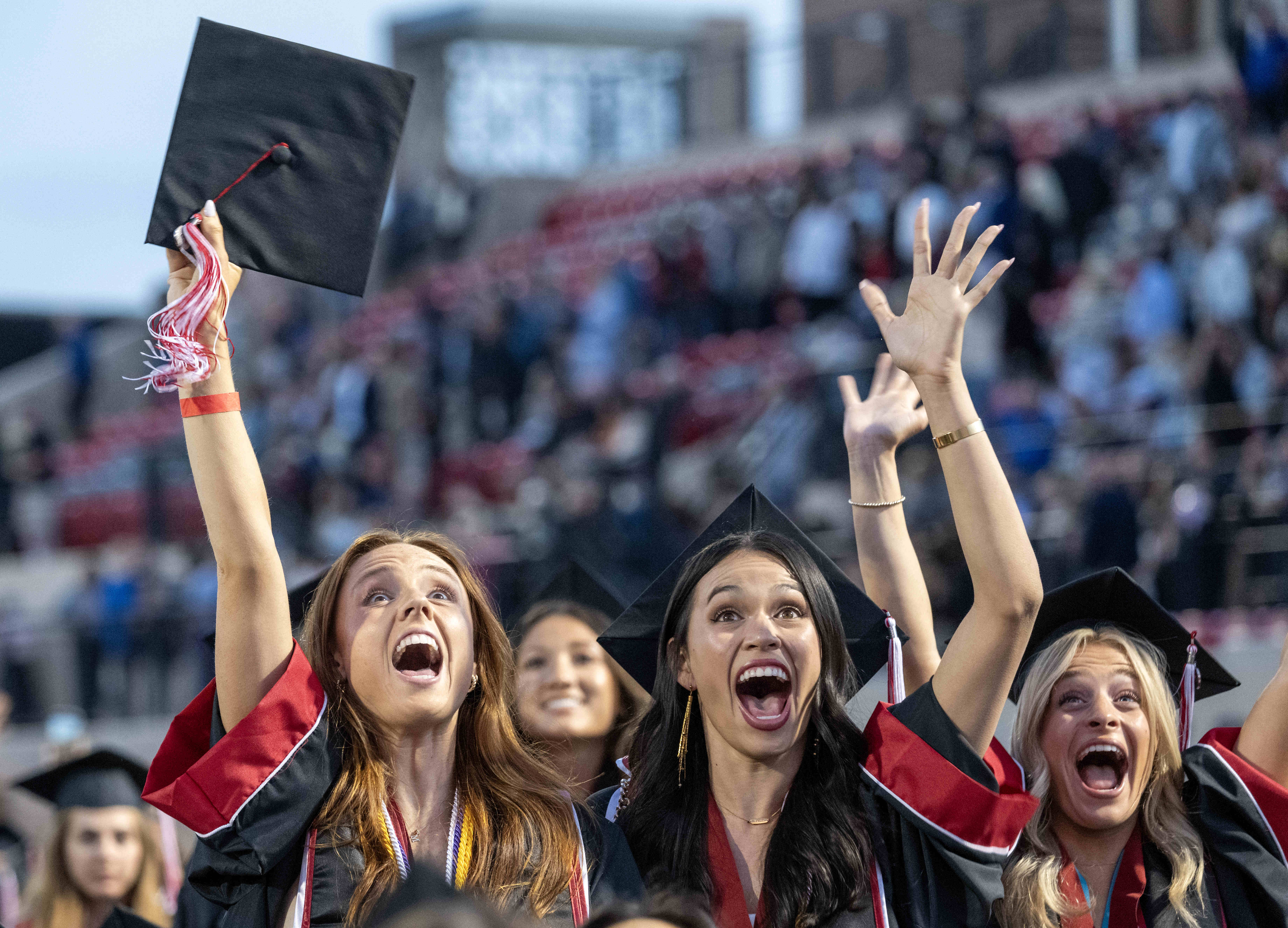 Chapman University graduates celebrate after moving their tassels and becoming...