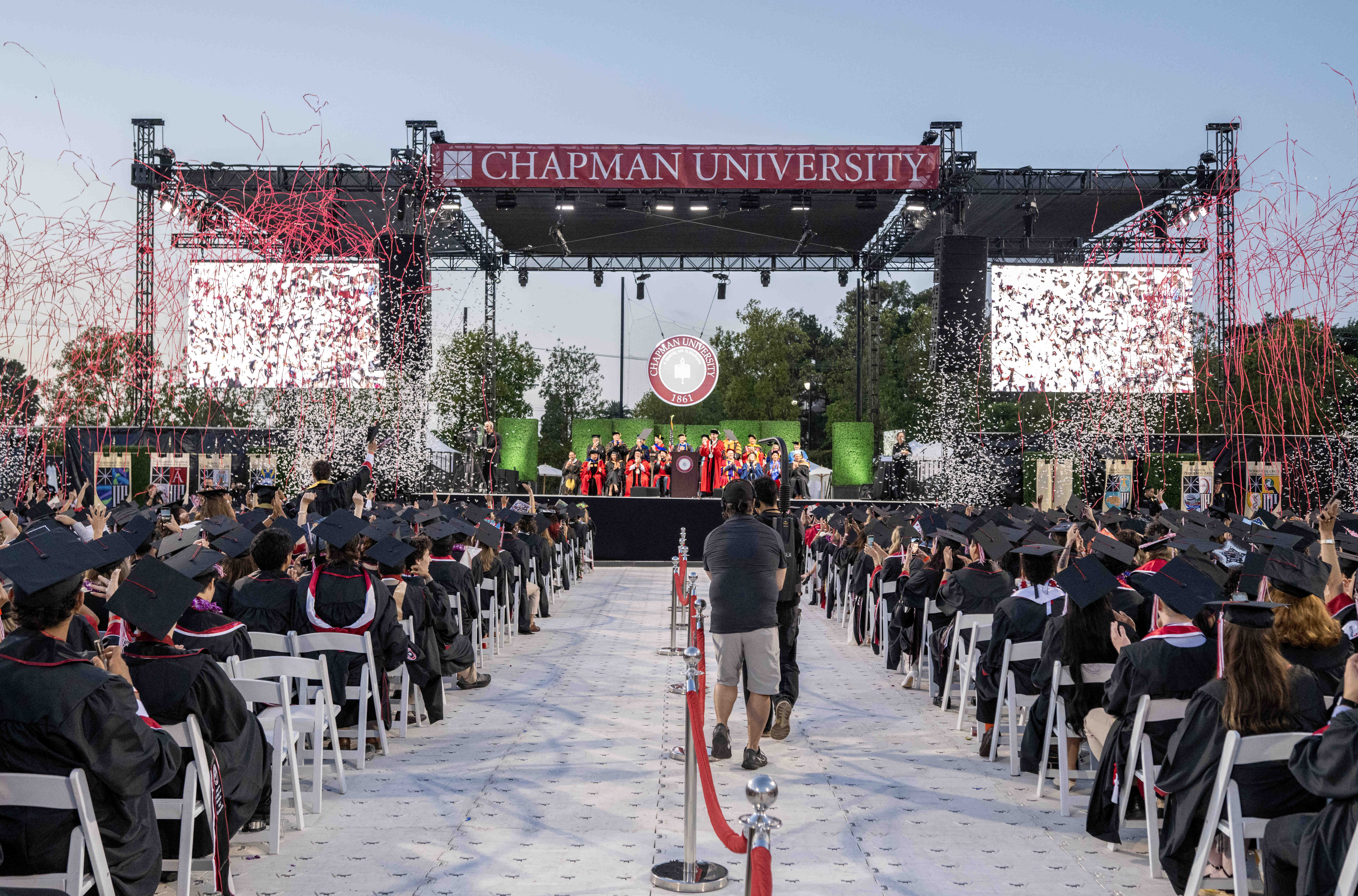 Confetti launches over the graduates at the conclusion of the...