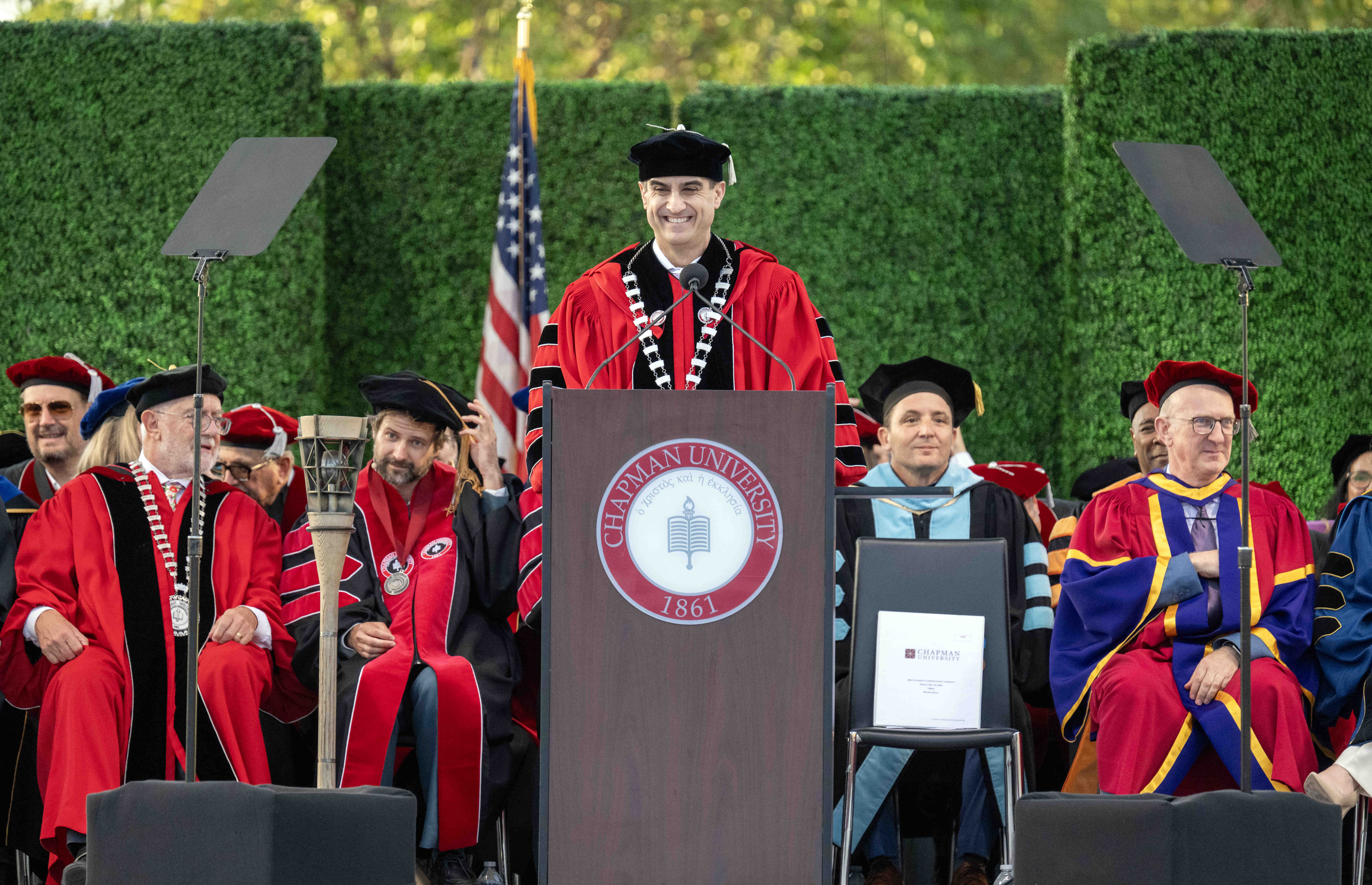 Chapman University President Matt Parlow speaks to graduates and their...