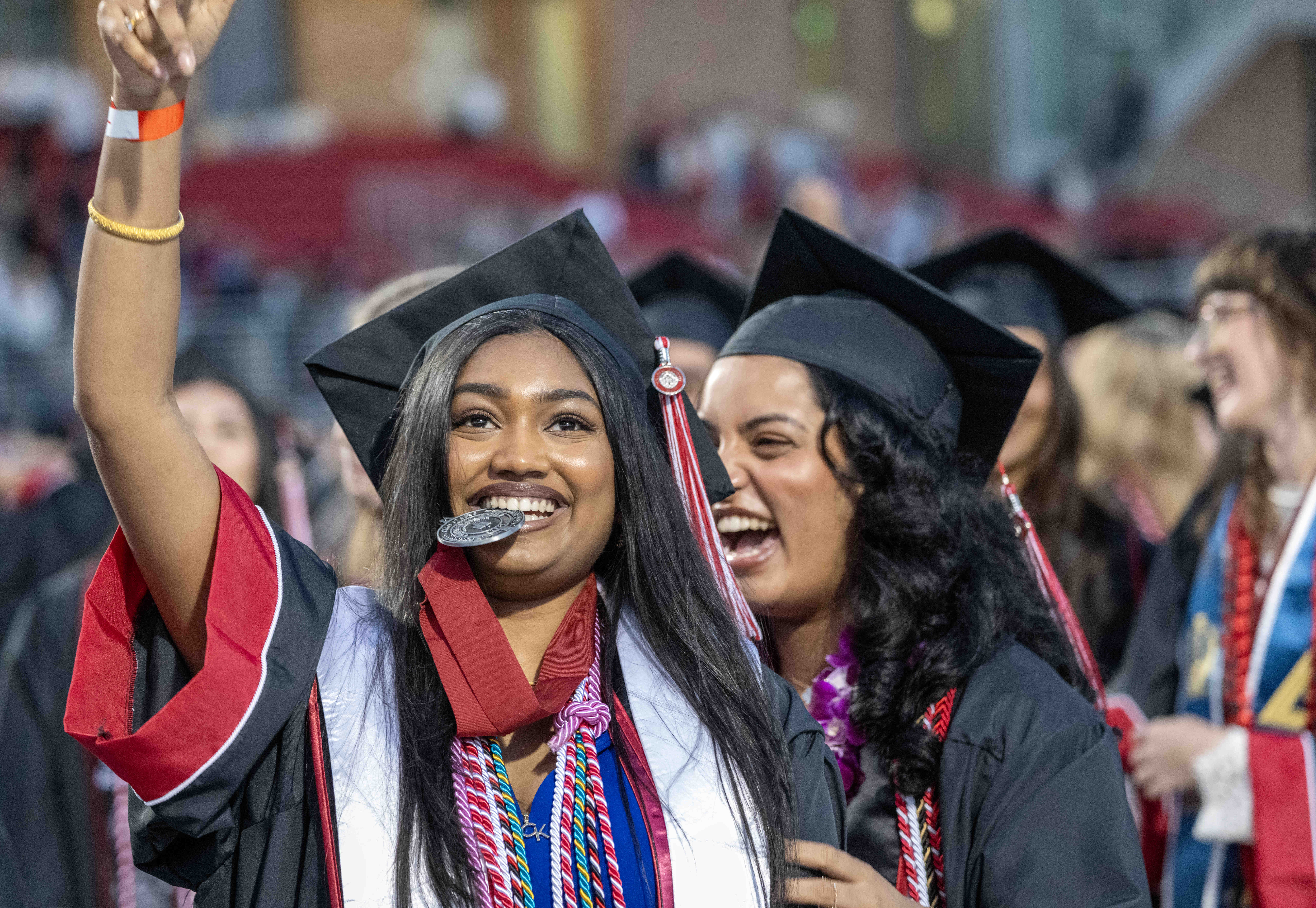 Chapman University graduates celebrate after moving their tassels and becoming...