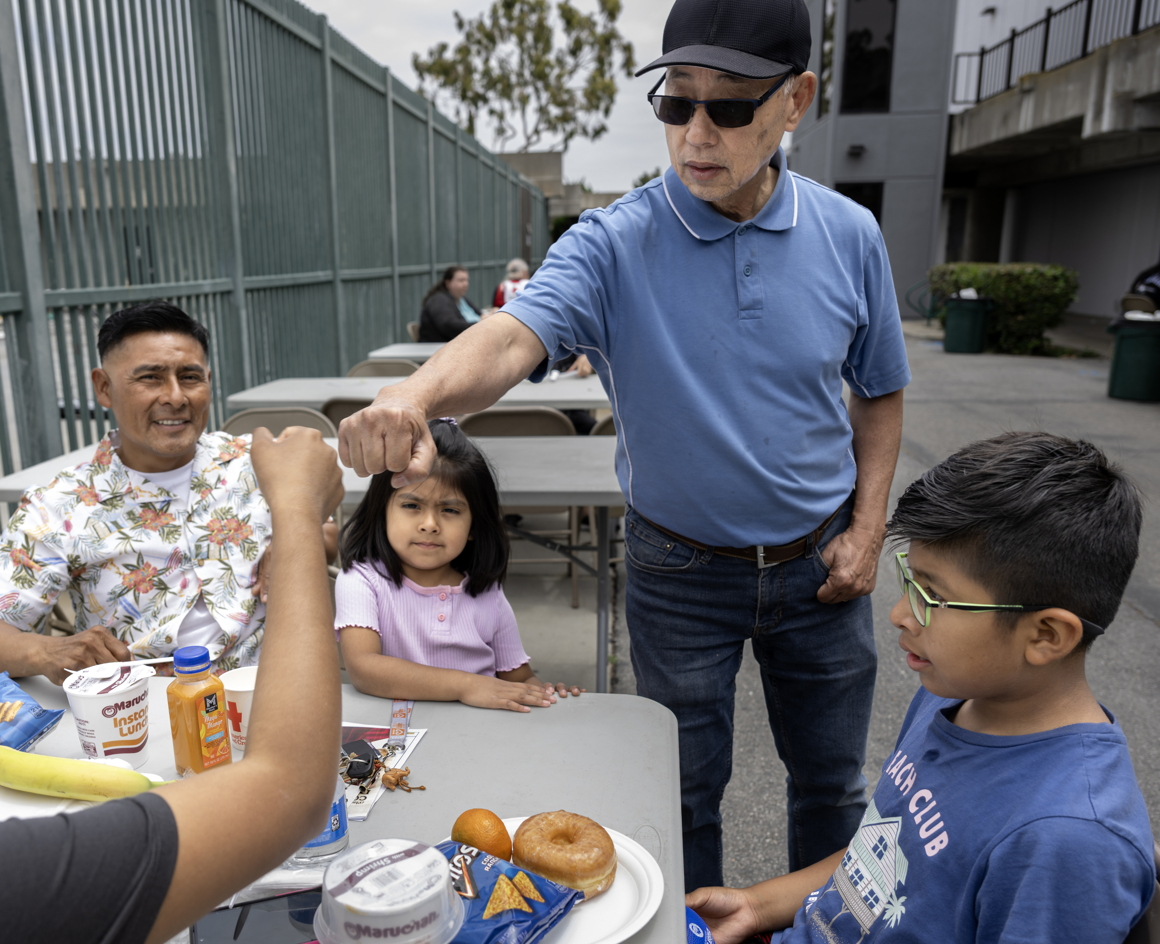 John Nguyen chats with the Arcos family at the Golden...