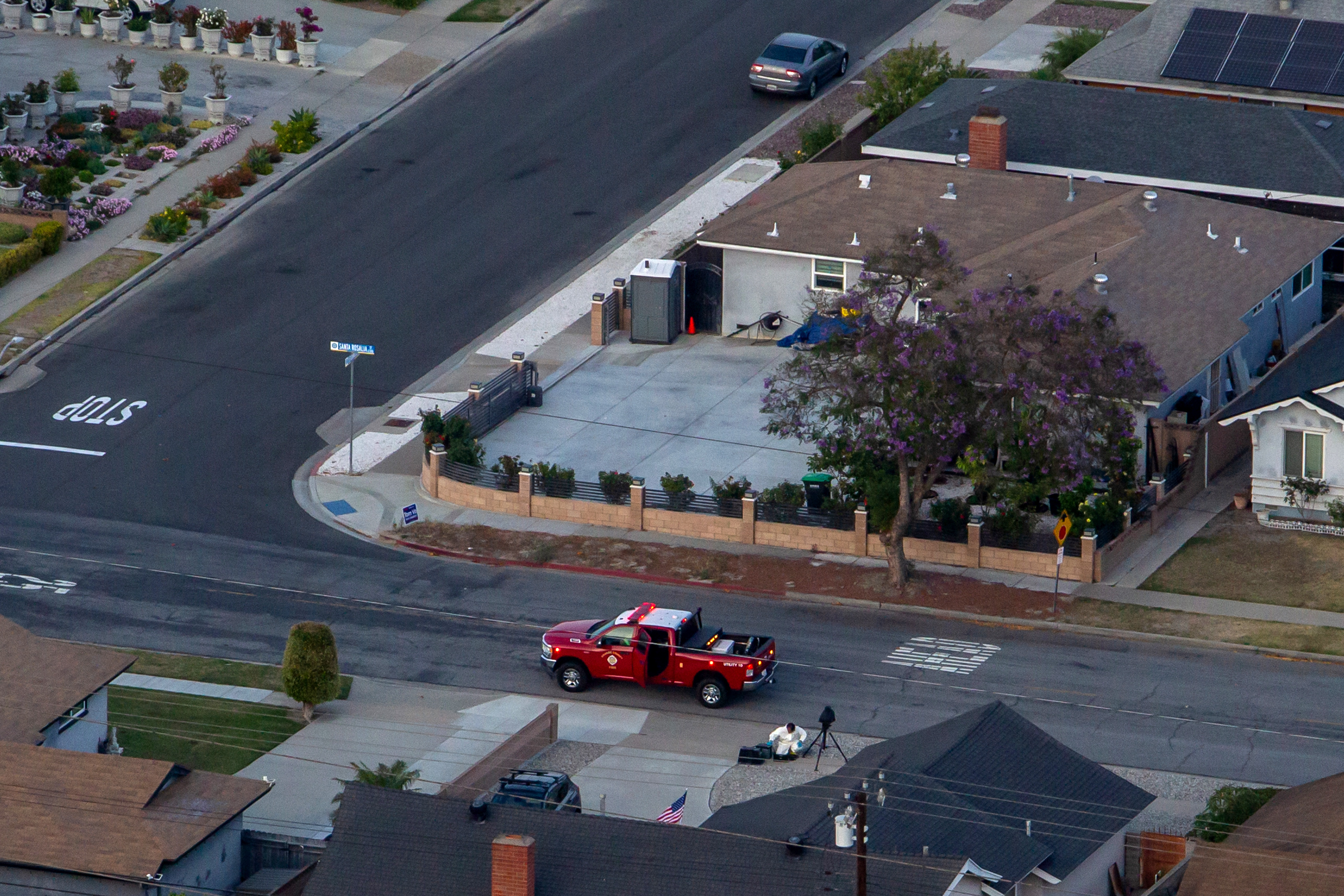 An aerial view of a man wearing protective hazmat suit...