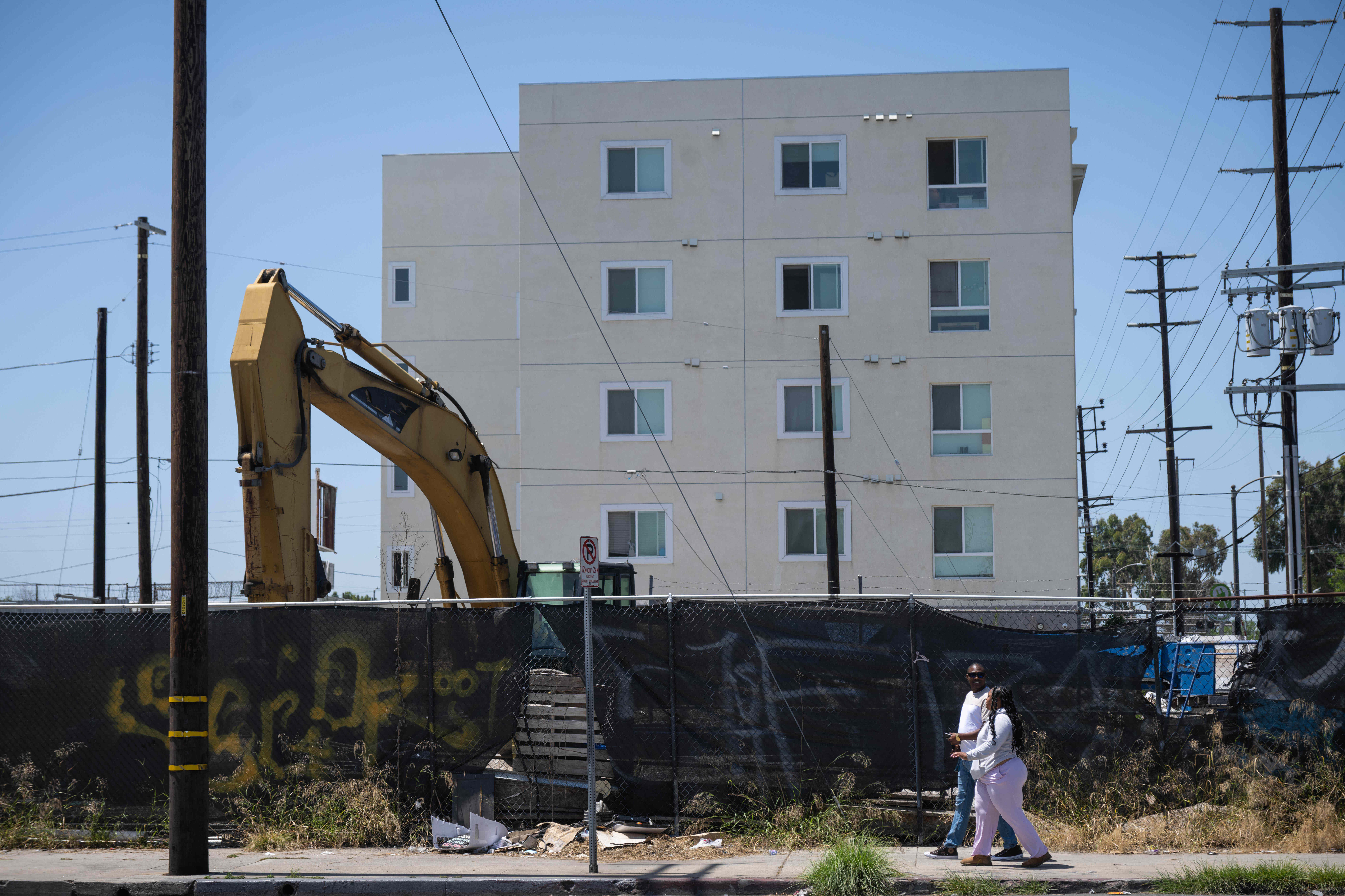 People walk past Harvest Tabernacle Bible Church property in Southeast...