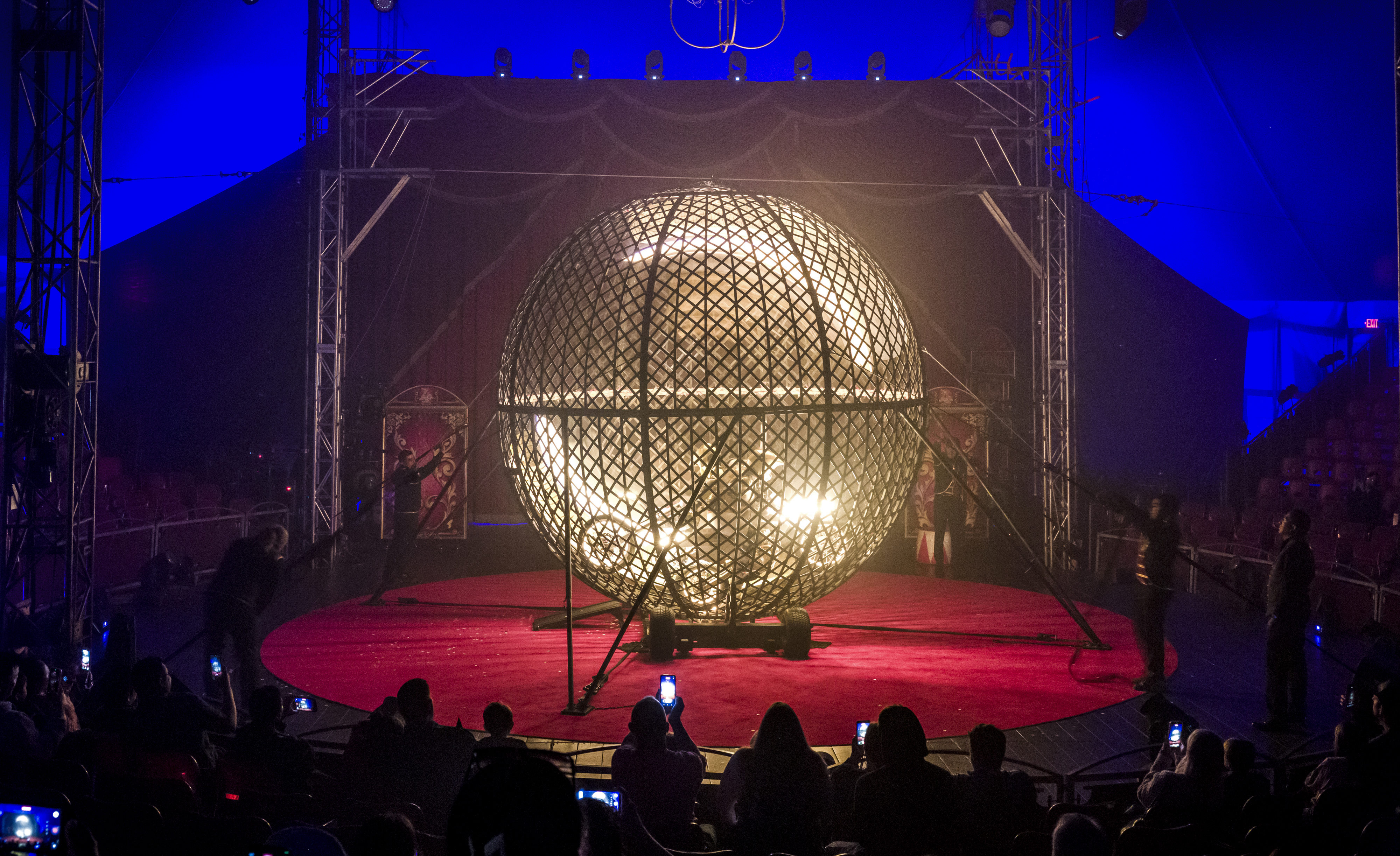 Four motorcycle riders zoom around the interior of âThe Globe...
