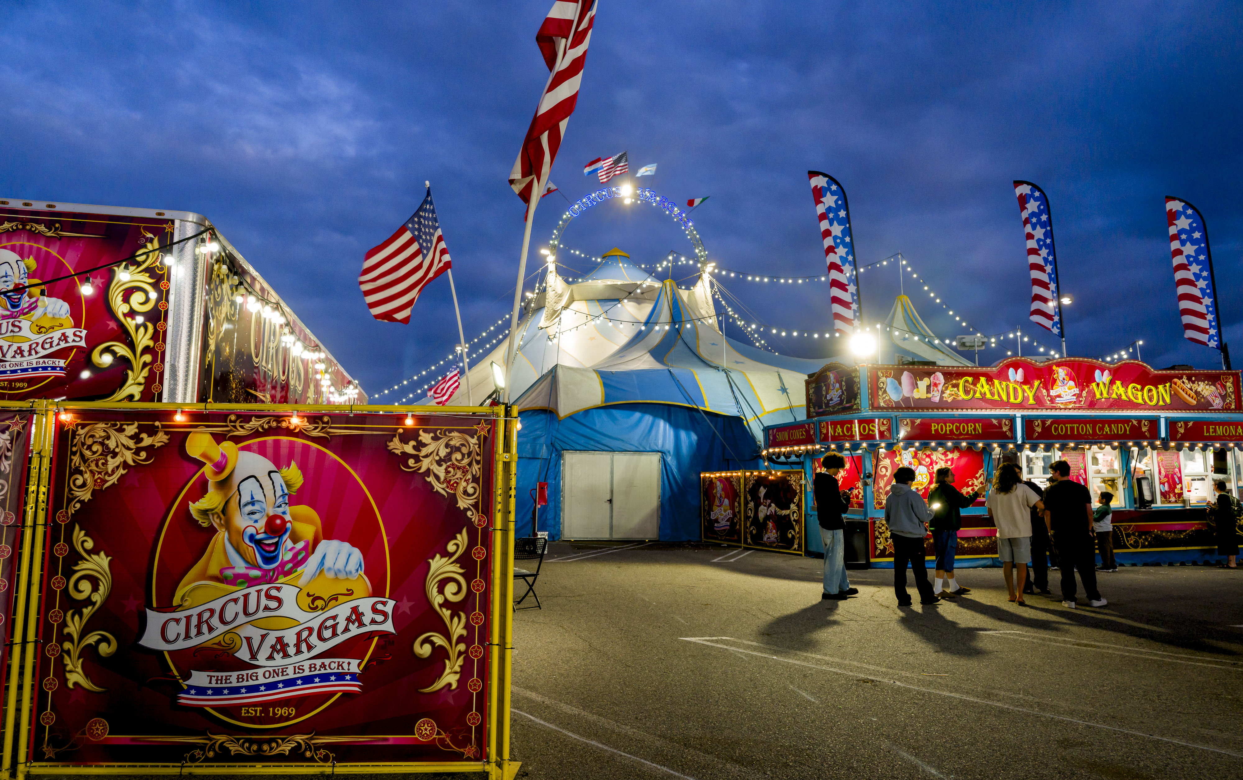 Guests by food outside the Circus Vargas big tent during...