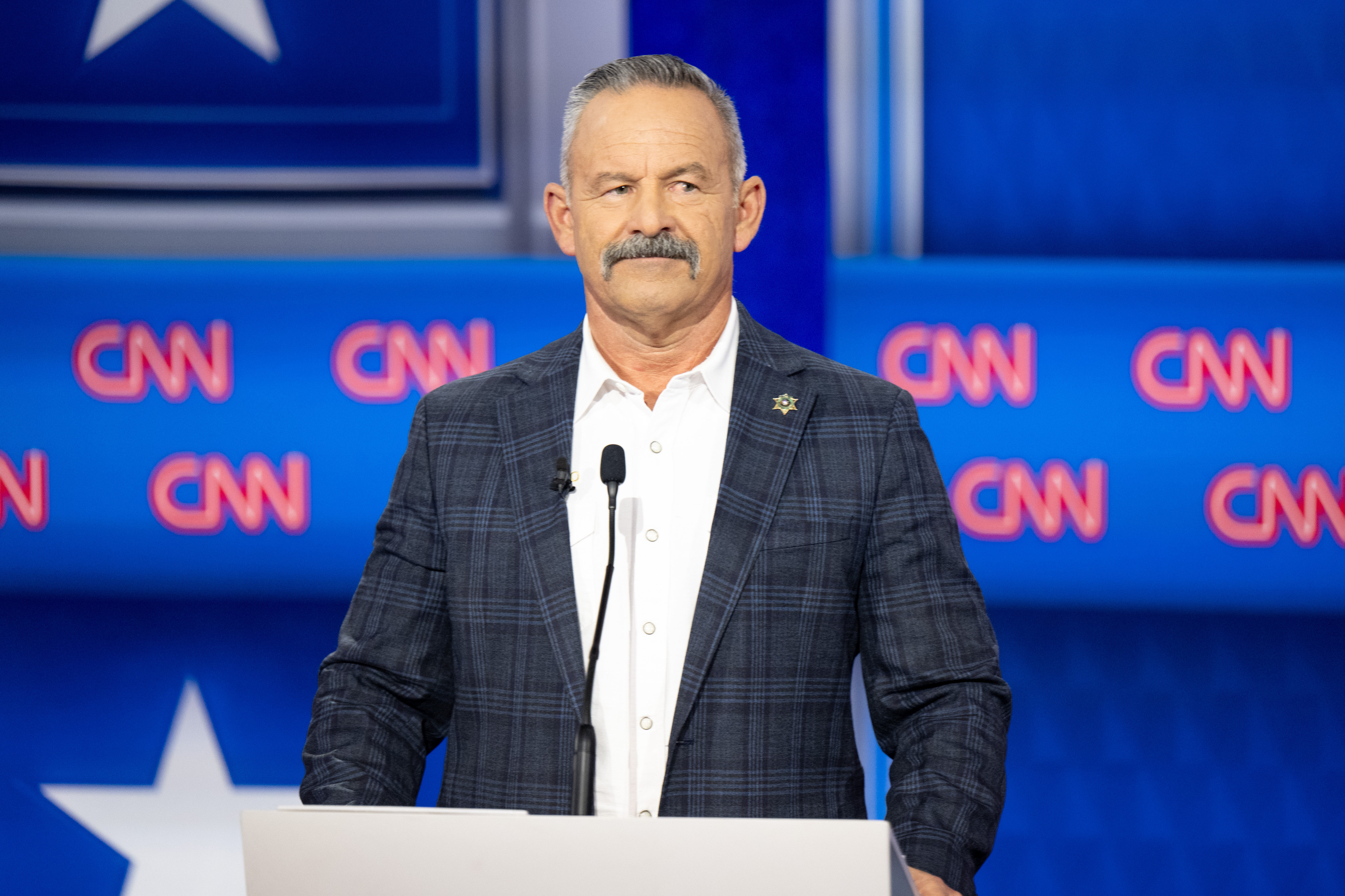 Chad Bianco, candidate for governor of California, on the stage...