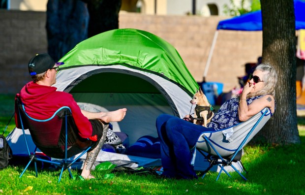 Evacuees Damien Derheim and his mother, Patty Derheim, along with their dog, Banjo, hang out at their tent at the Elks Lodge in Garden Grove on Sunday, May 24, 2026. Nearly 50,000 people were displaced from their homes over Memorial Day weekend as first responders worked to prevent an overheated storage tank from exploding or spilling up to 7,000 gallons of the chemical methyl methacrylate. (Photo by Jeff Gritchen, Orange County Register/SCNG)
