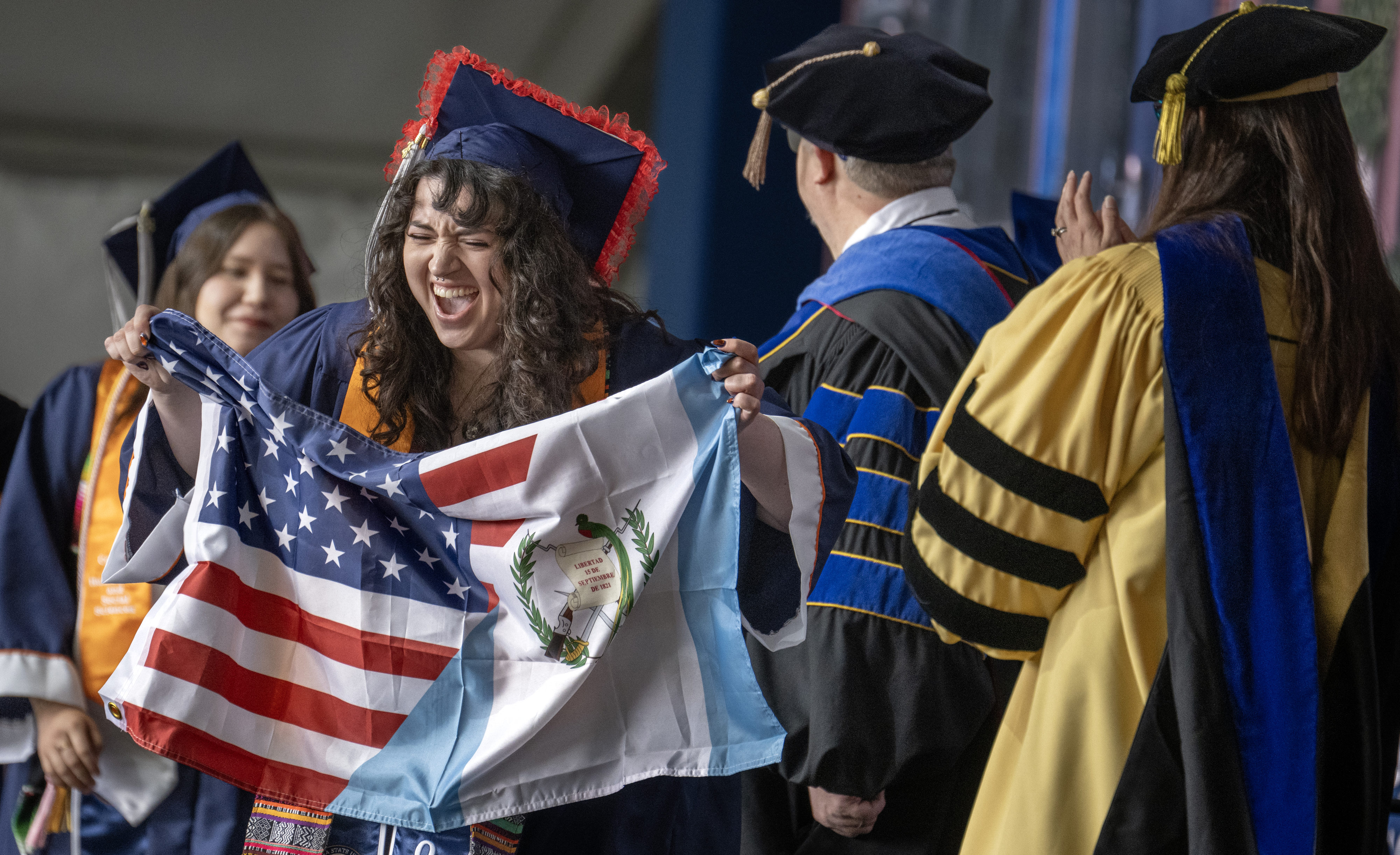 Jessie Strahan shows off an American/Guatemalan flag as she goes...