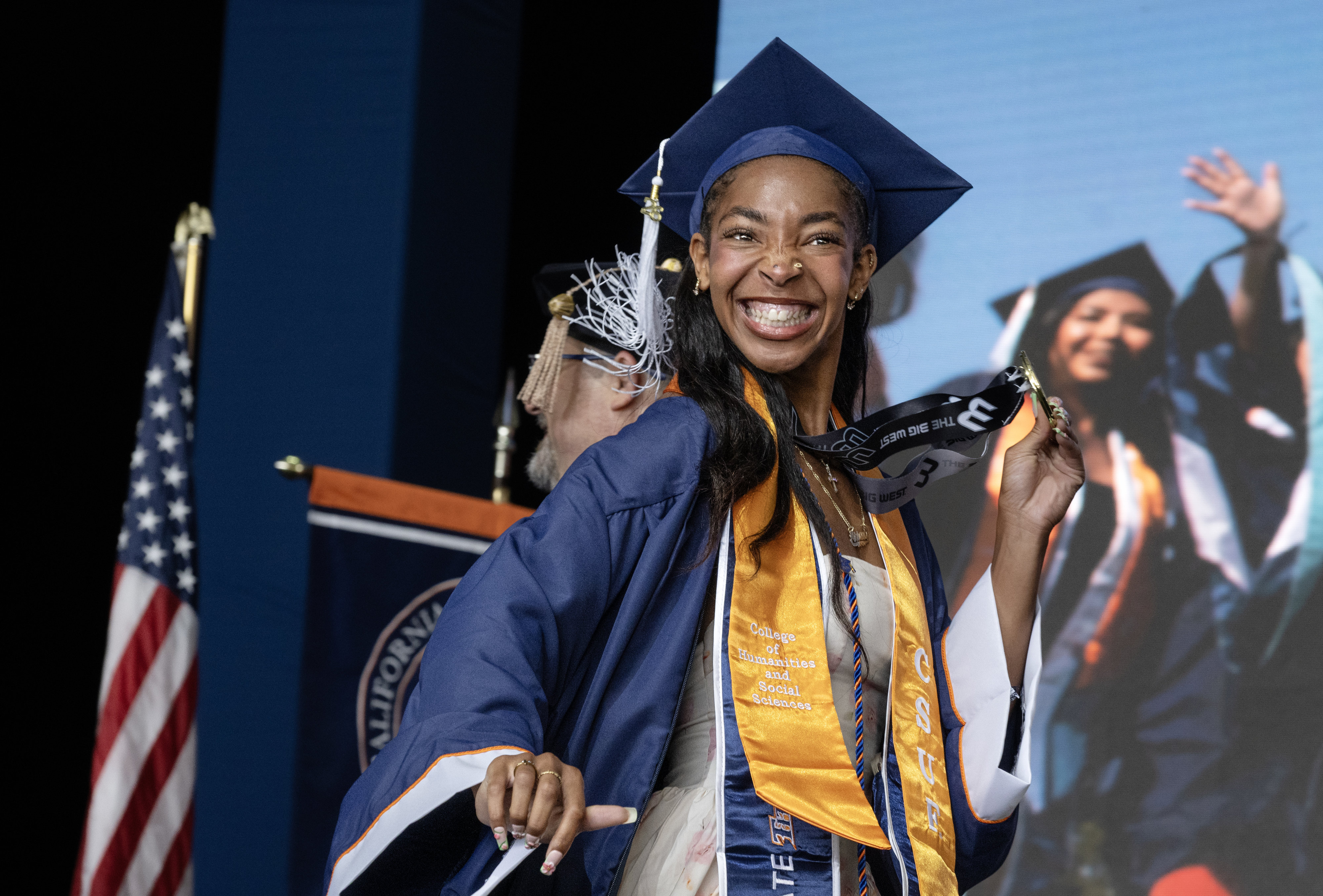 Honor Student Arionn Livingston holds her medallion as she walks...