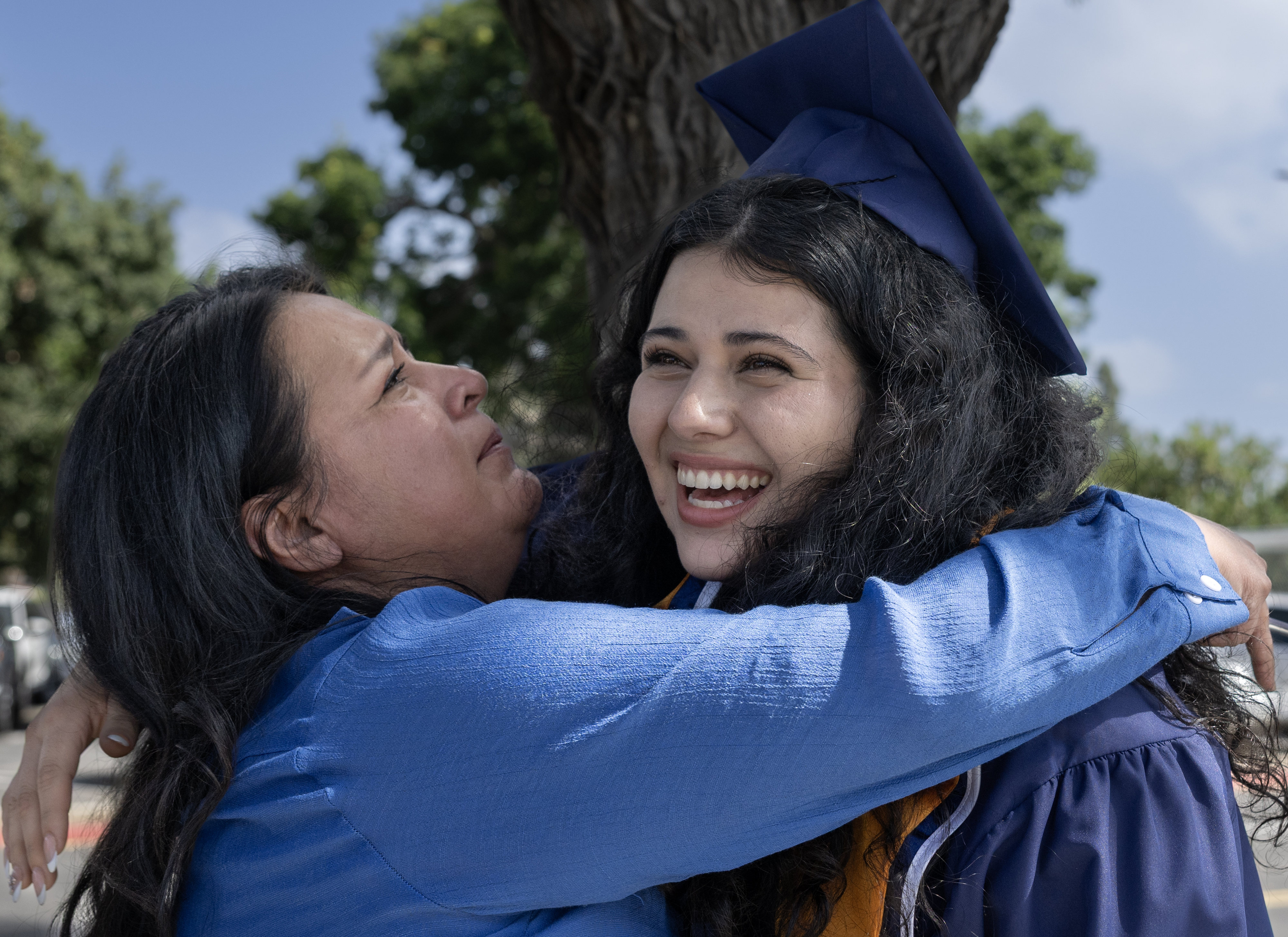 Cal State Fullerton graduate, Kabella Moll, gets an emotional hug...