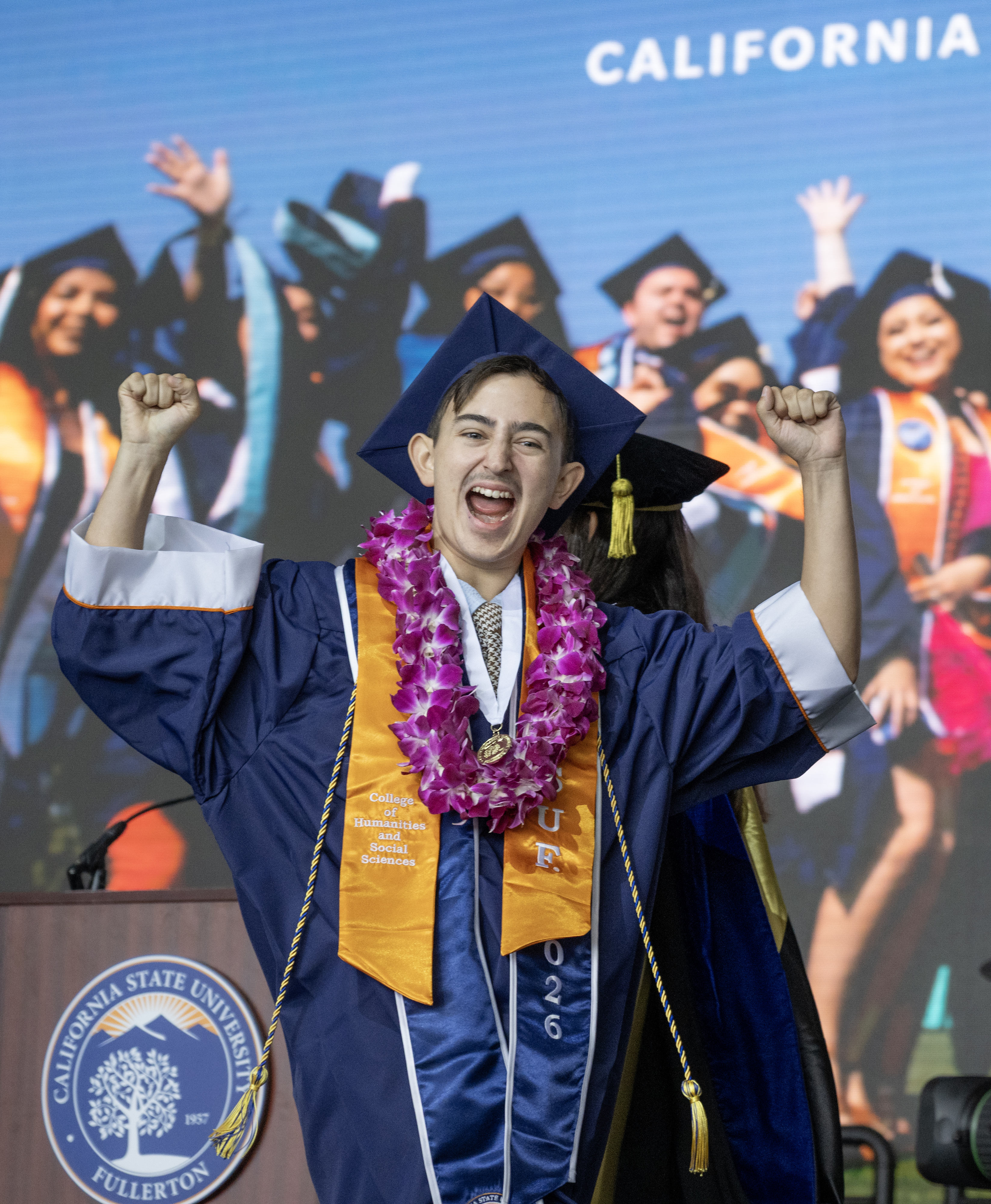 An enthusiastic Andrew Bonilla graduates from Cal State Fullertonâs College...