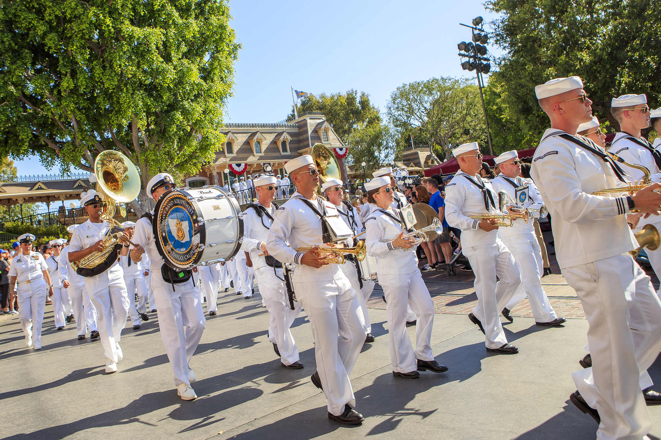 The Navy Band Southwest march through Disneyland Town Square during...