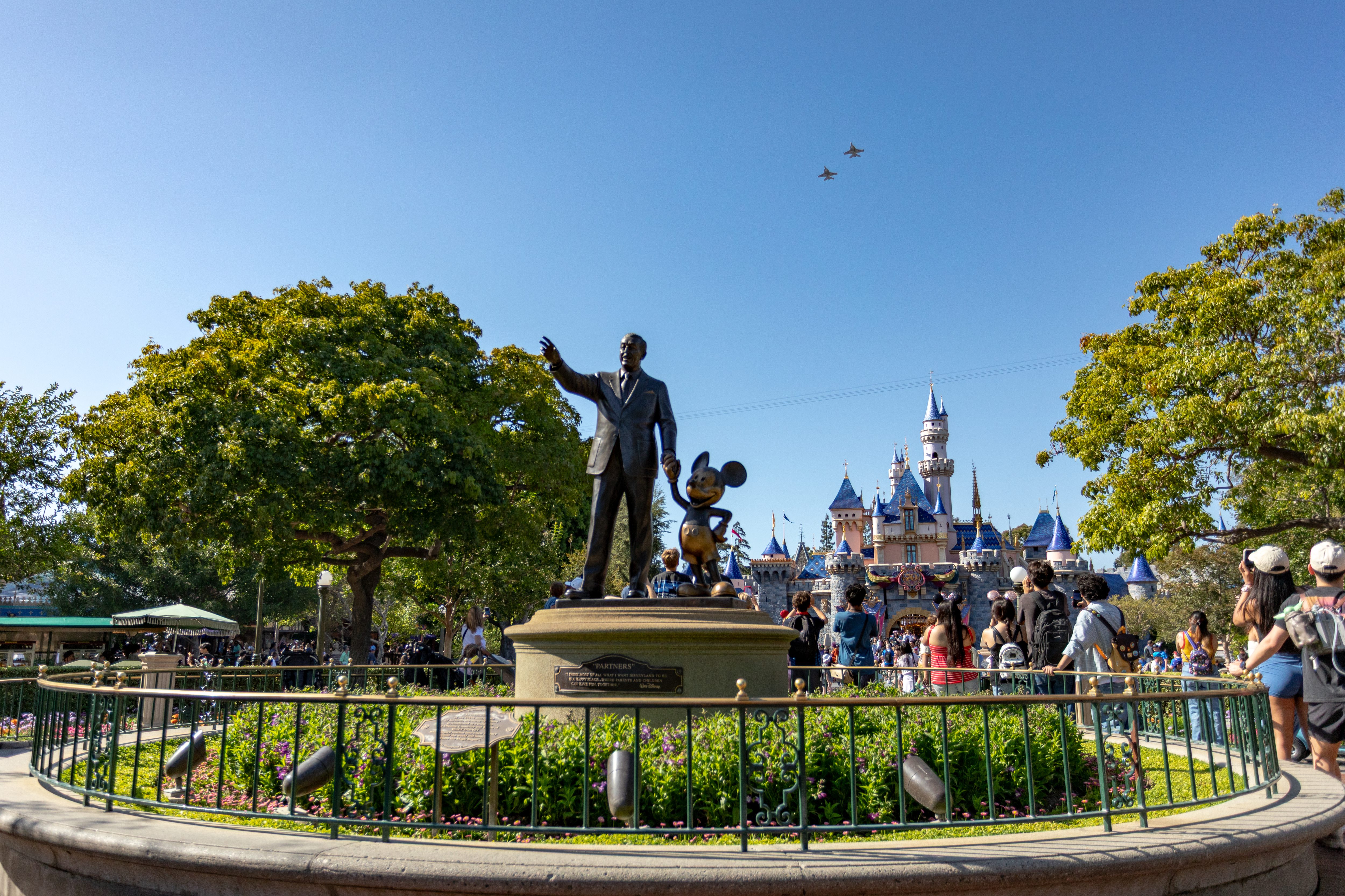 Two U.S. Navy F-18 Super Hornets fly over Disneyland during...