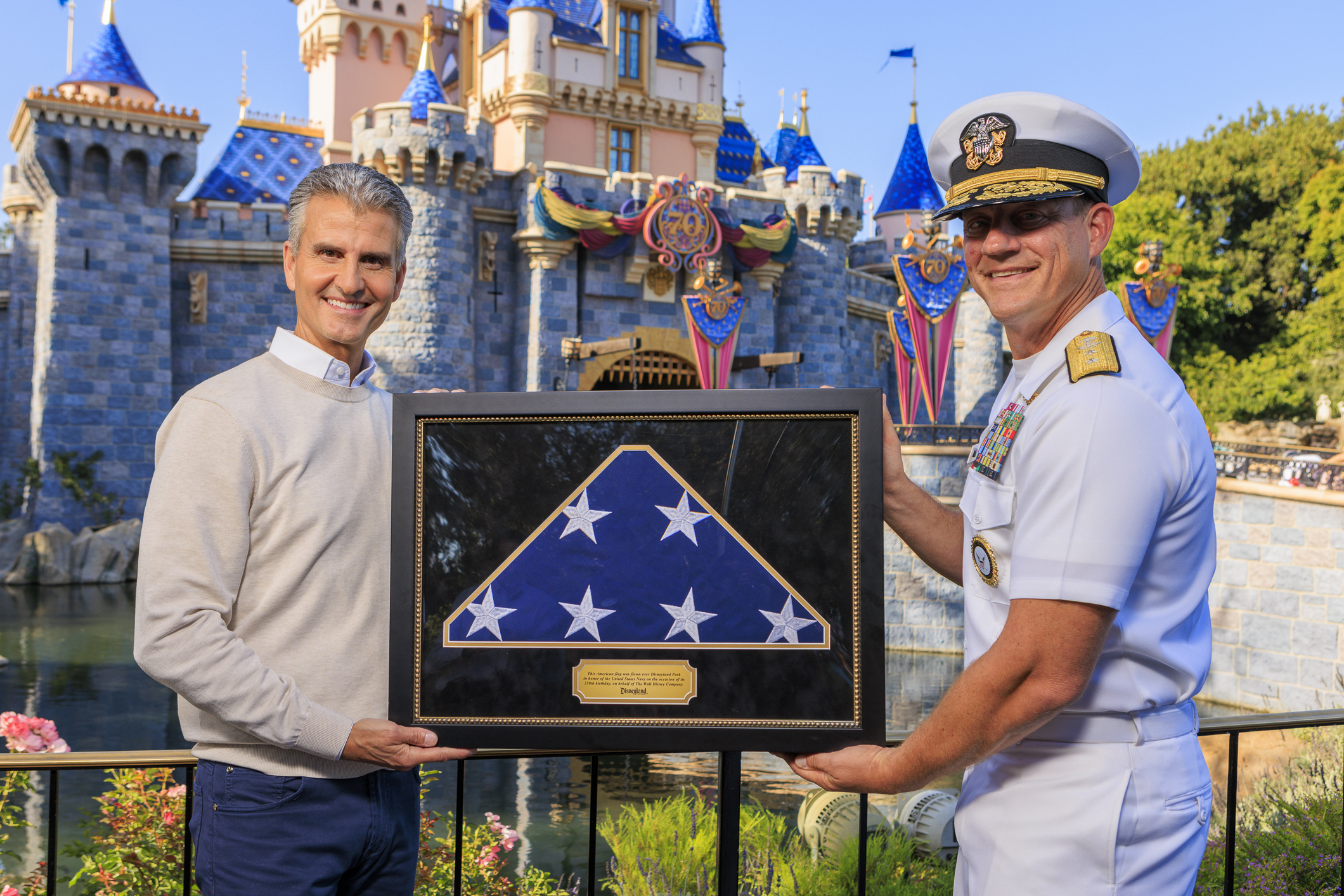 Disney CEO Josh D’Amaro presents Rear Adm. Robert Nowakowski with...