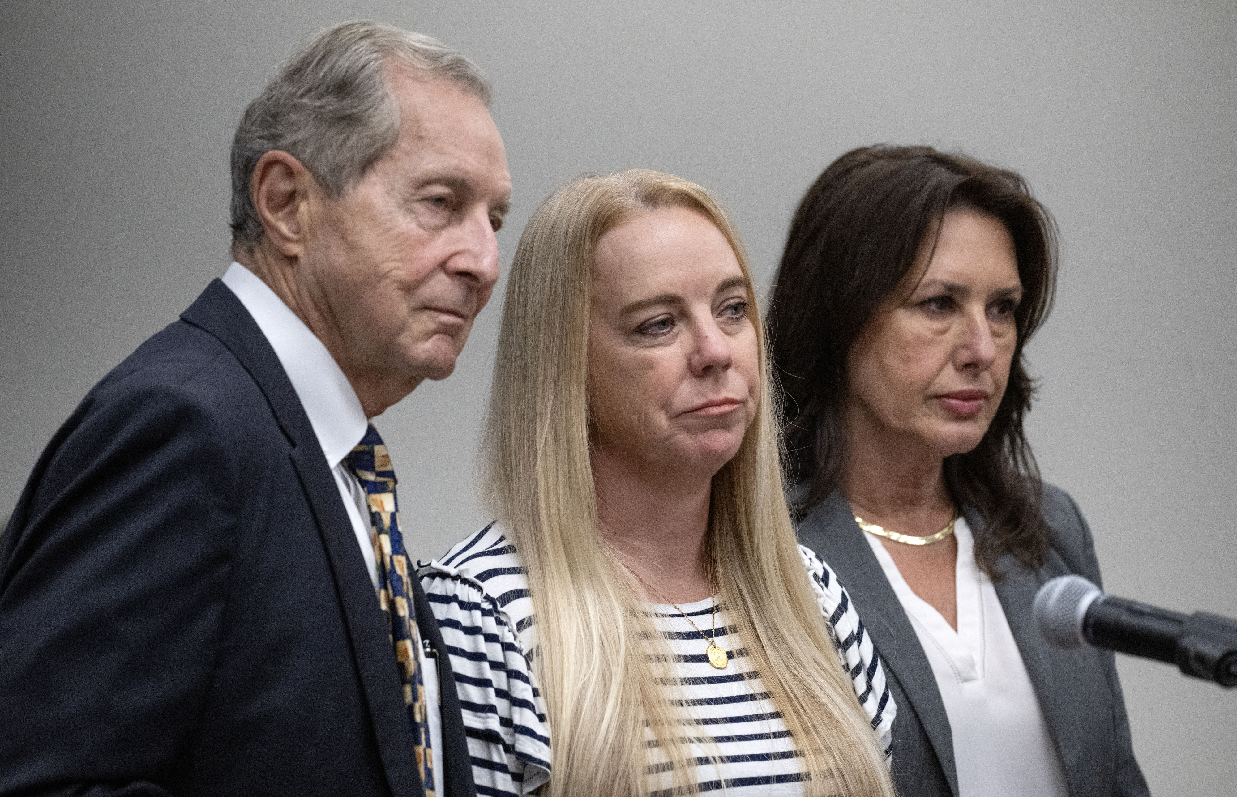 Tommi Jo Mejer, center, the mother of a 14-year-old accused...