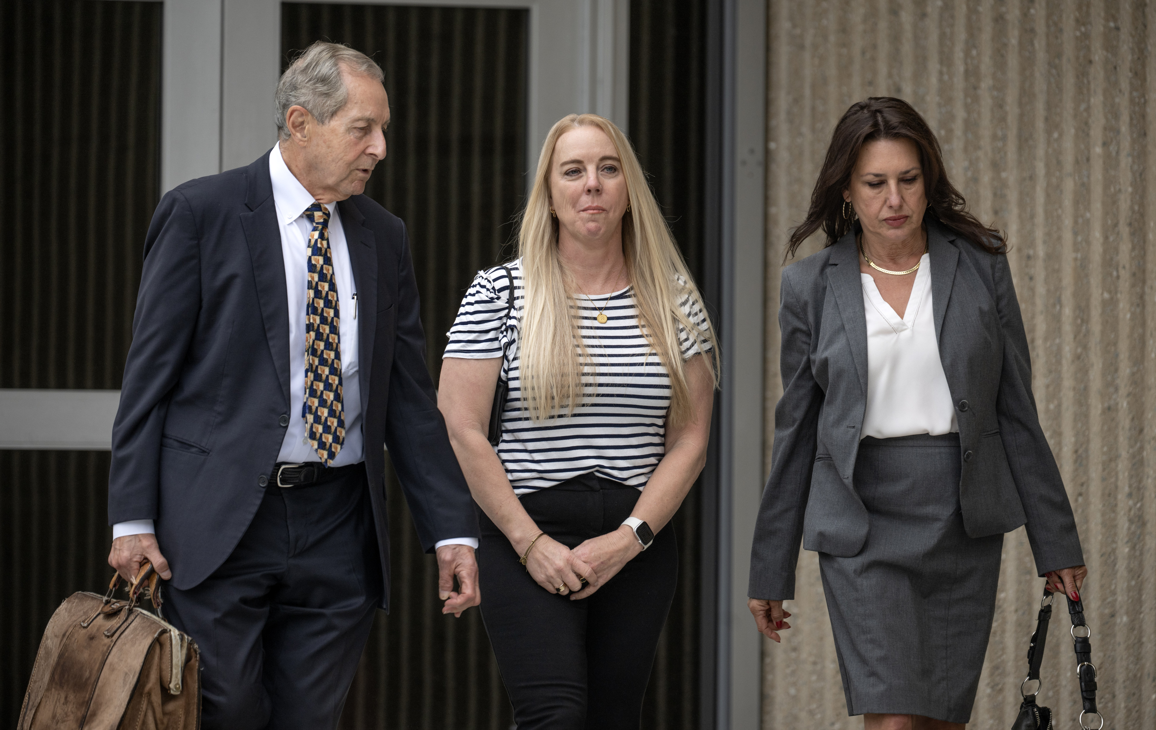 Tommi Jo Mejer, center, the mother of a 14-year-old accused...