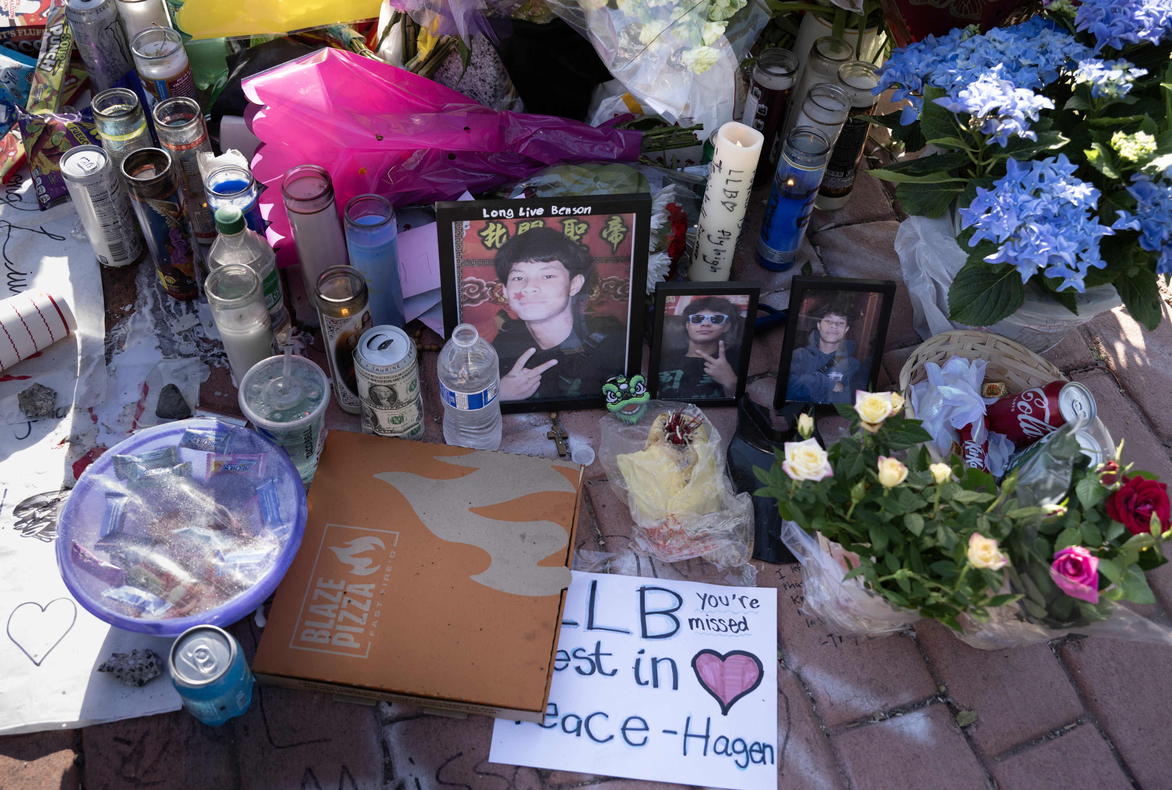 Messages, photos, flowers and food are left at the crash...