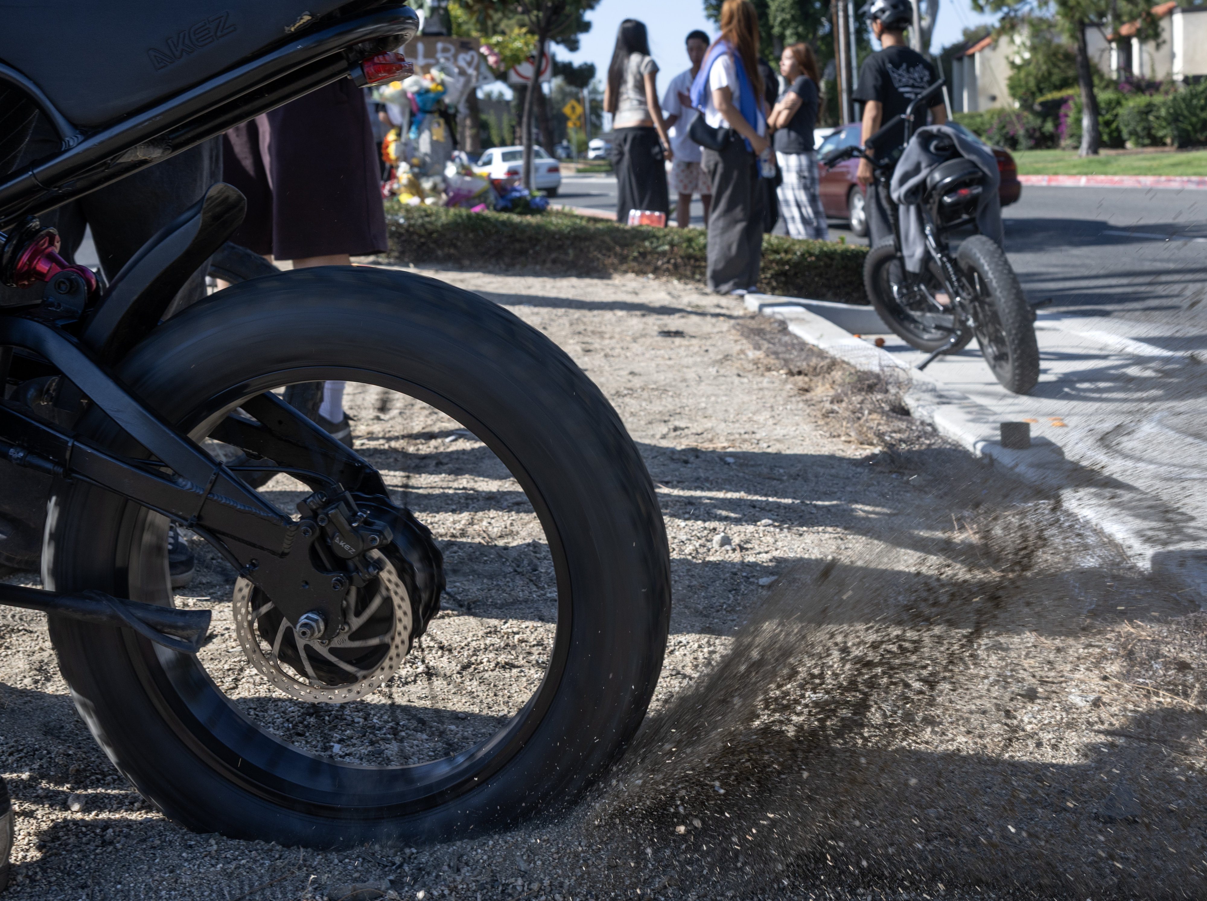A mourner spins his rear tire at the accident site...