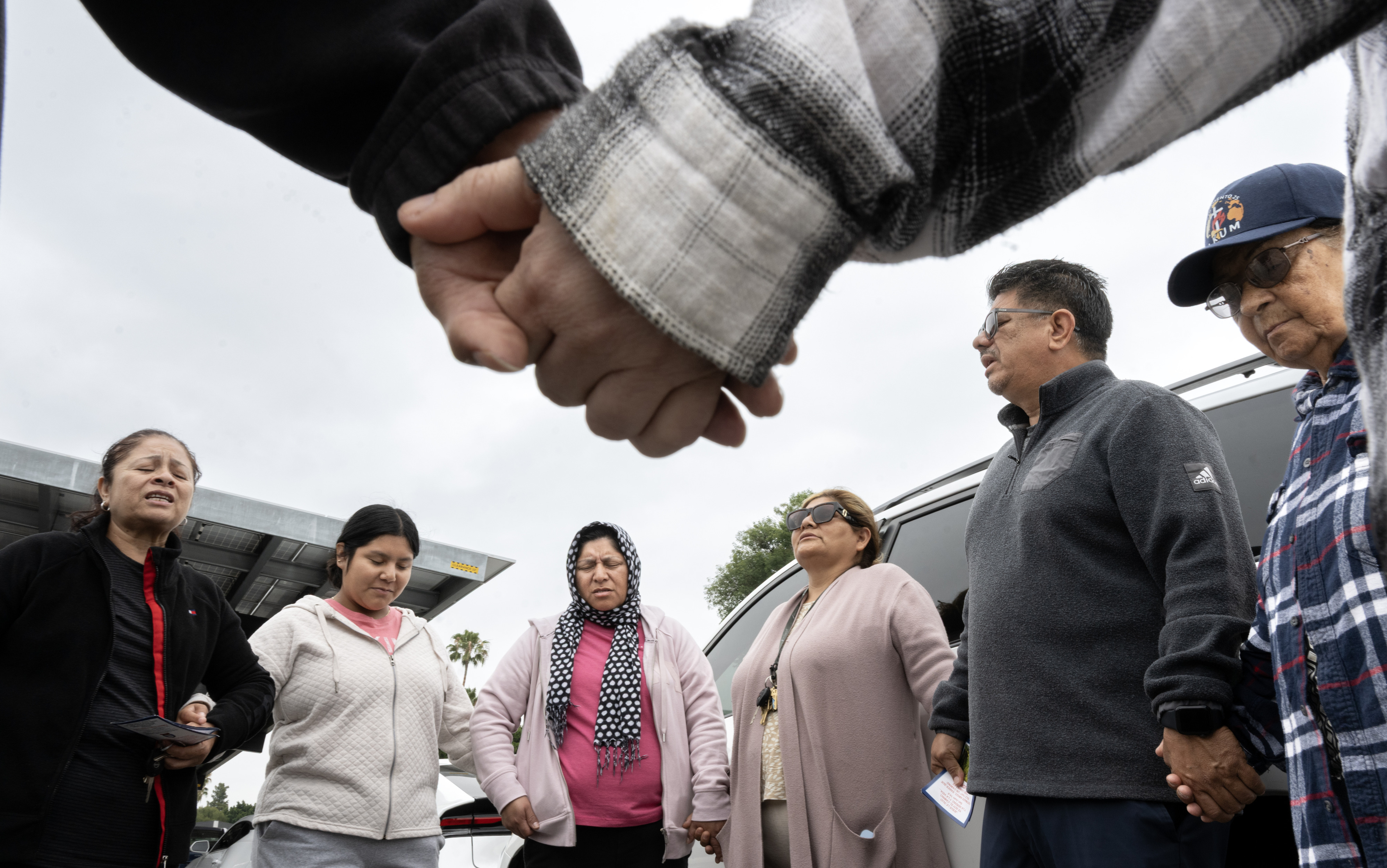 Members of Christ Breaks Chains church pray outside Savanna High...