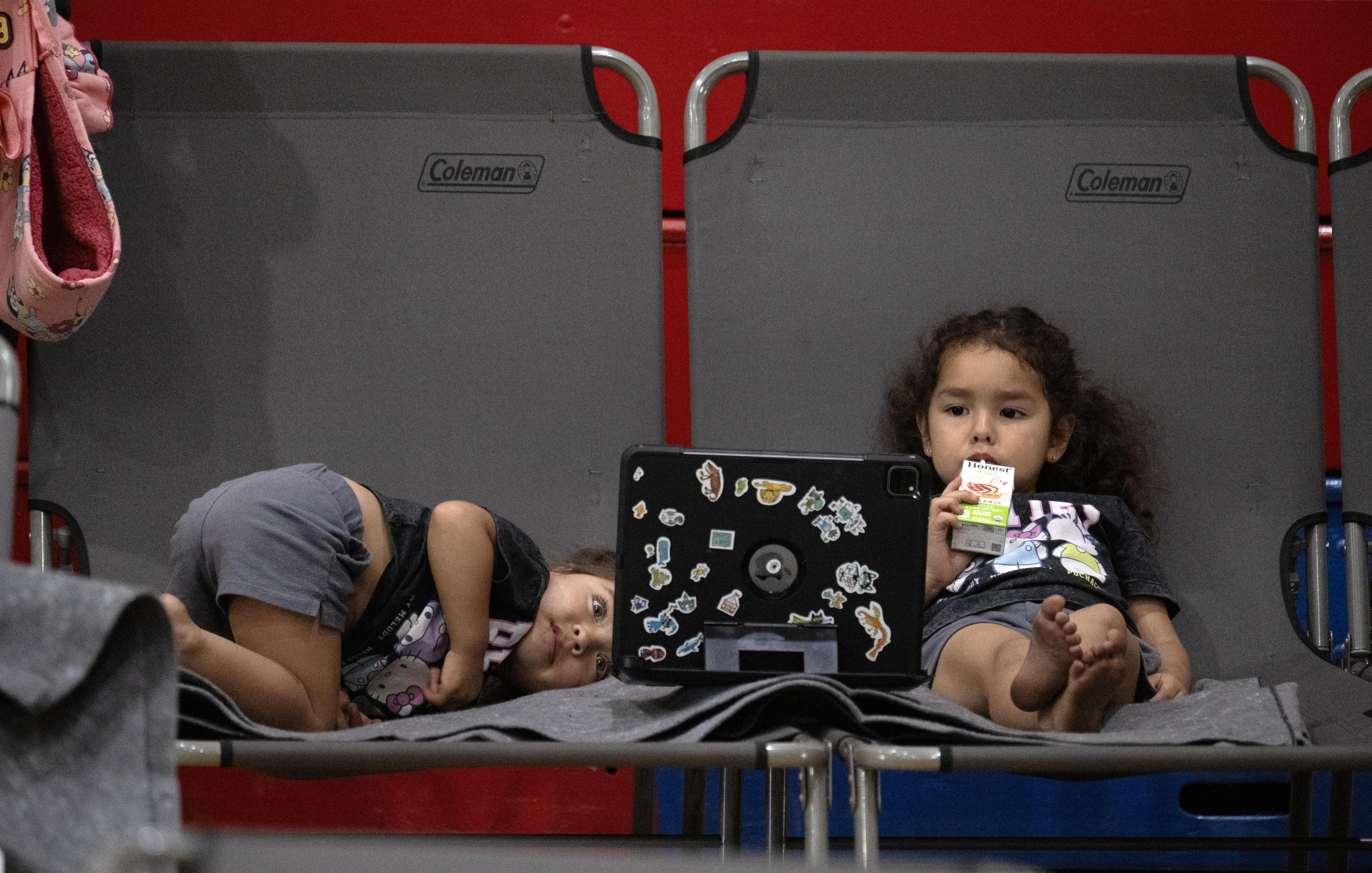 Oscar Maye keeps his daughters, Lucia, 2, left and Violetta,...