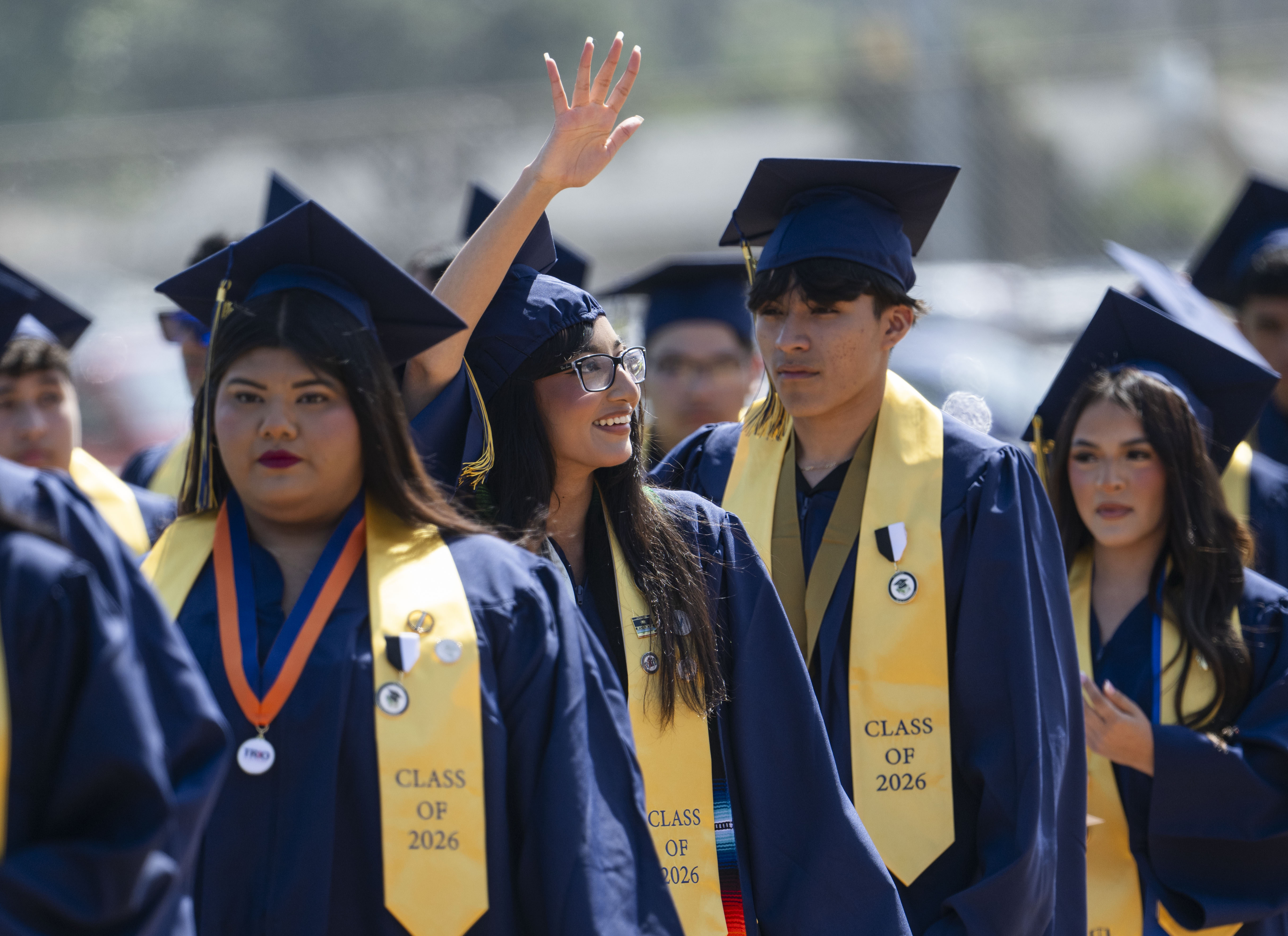 A graduate spots her family in the stands at Handel...