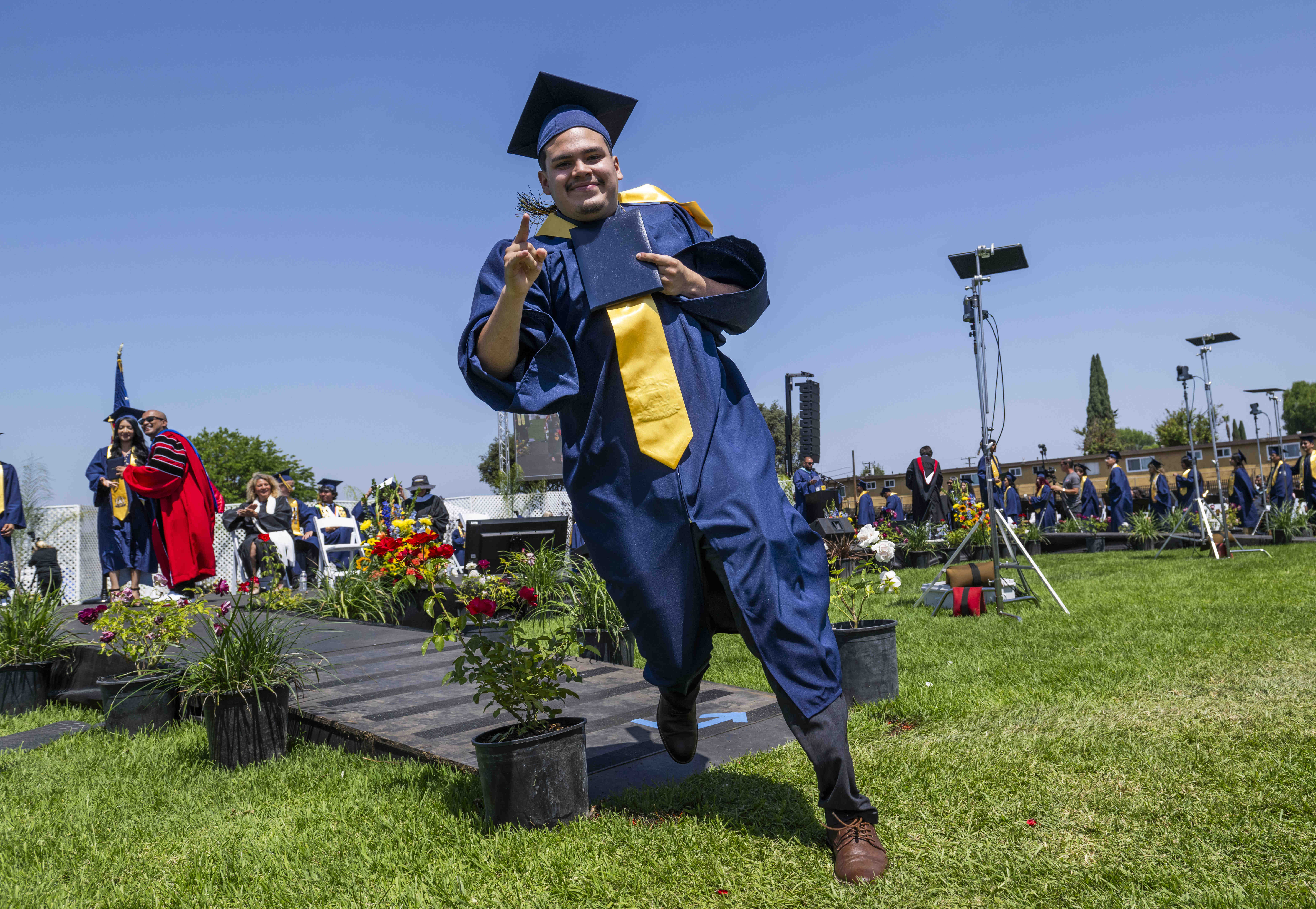 Robert De La Torre runs off the stage after receiving...