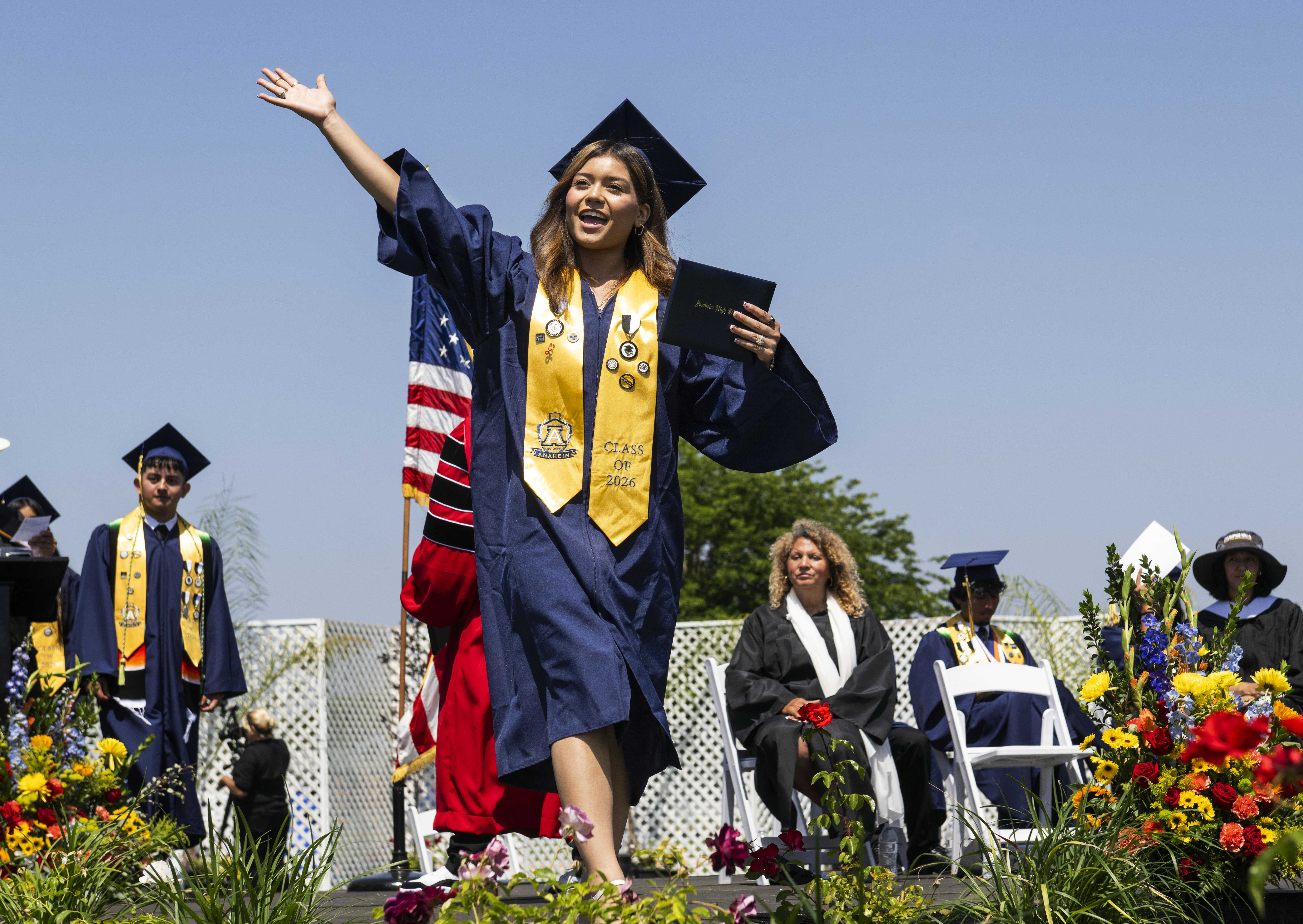 Katherine Valle waves to the crowd after receiving her diploma...