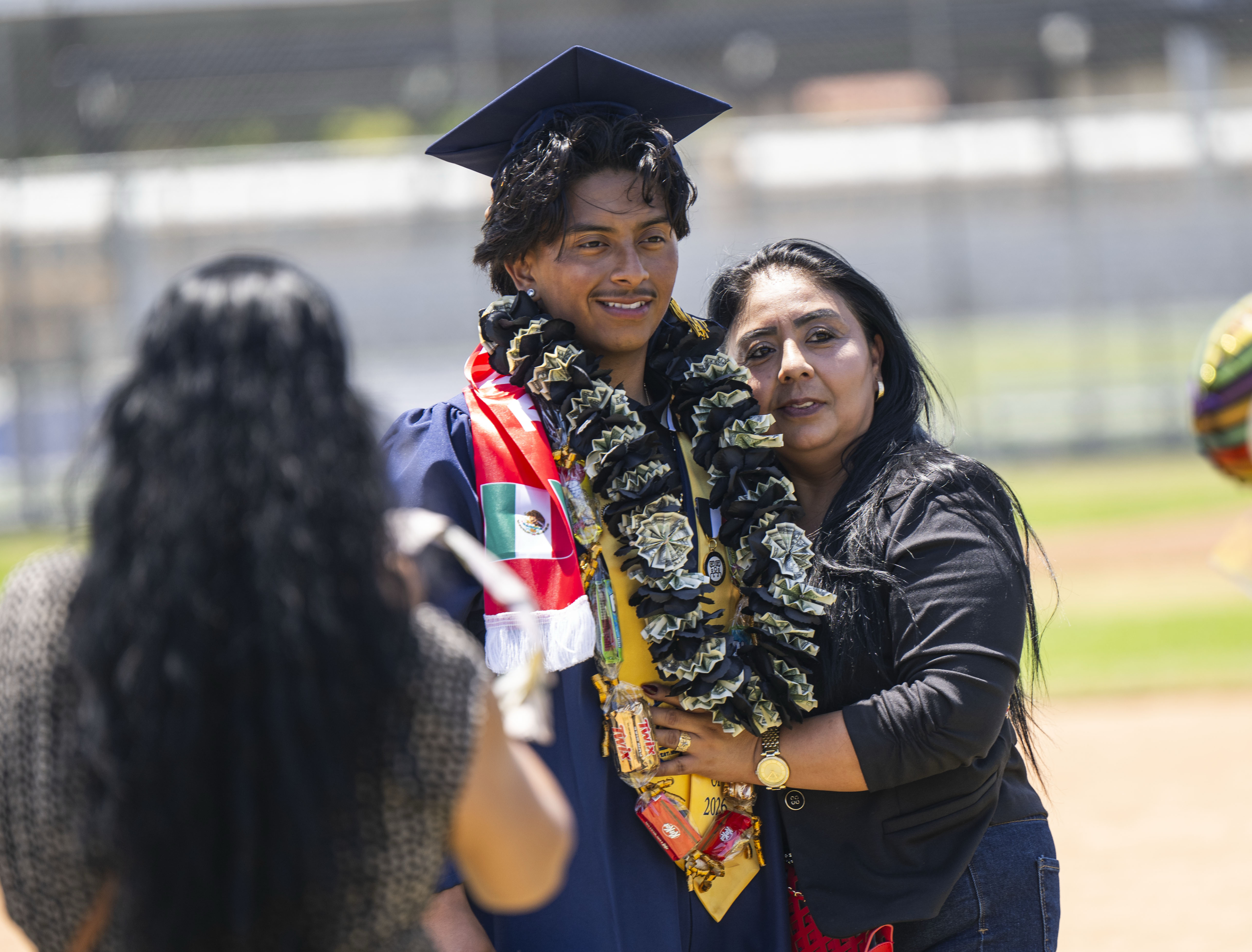 Graduate Isaac Aviles-Eriza has his photo taken with his mother...