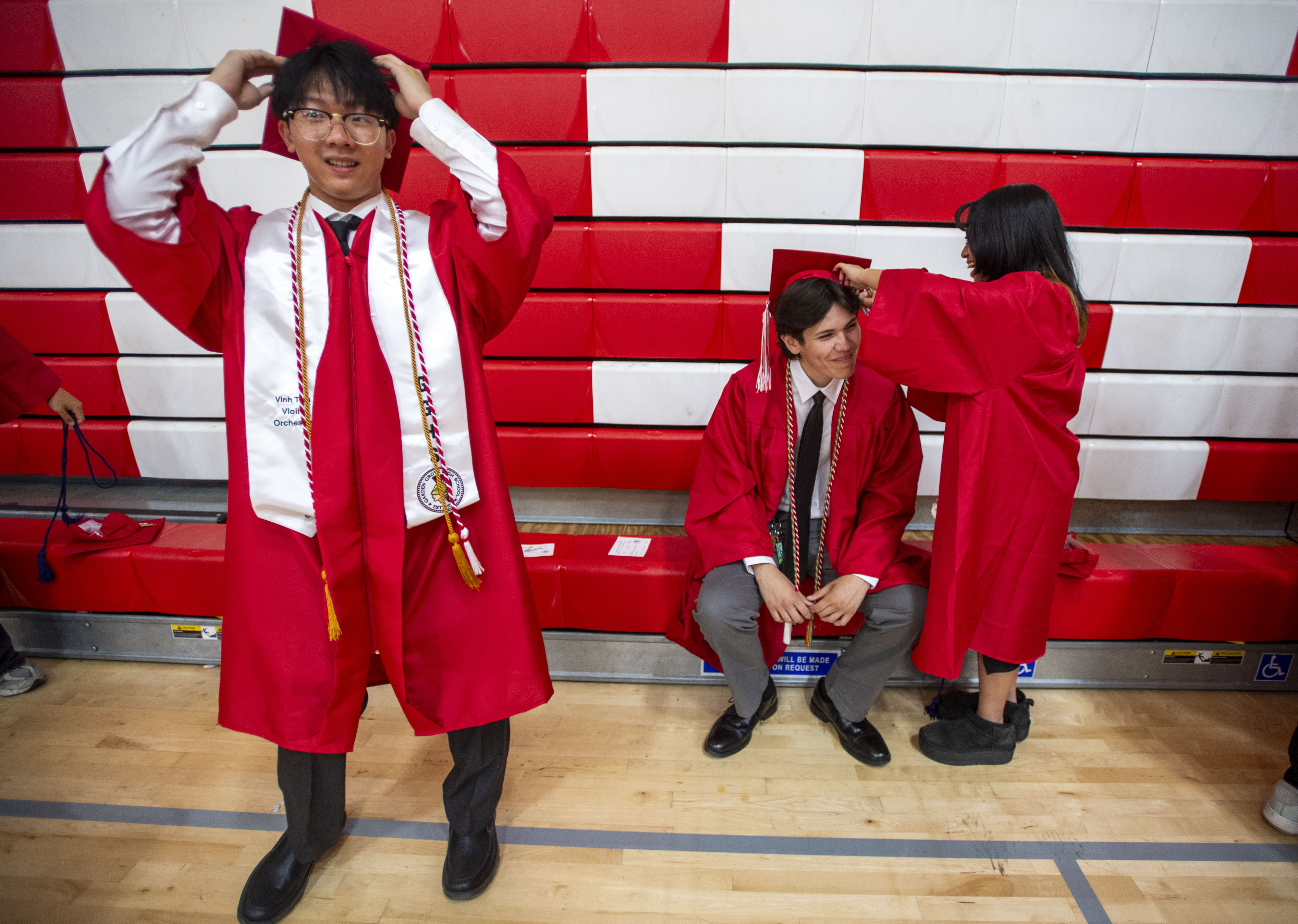 Vinh Tran adjusts his cap as Jenna Nguyen secures Aiden...