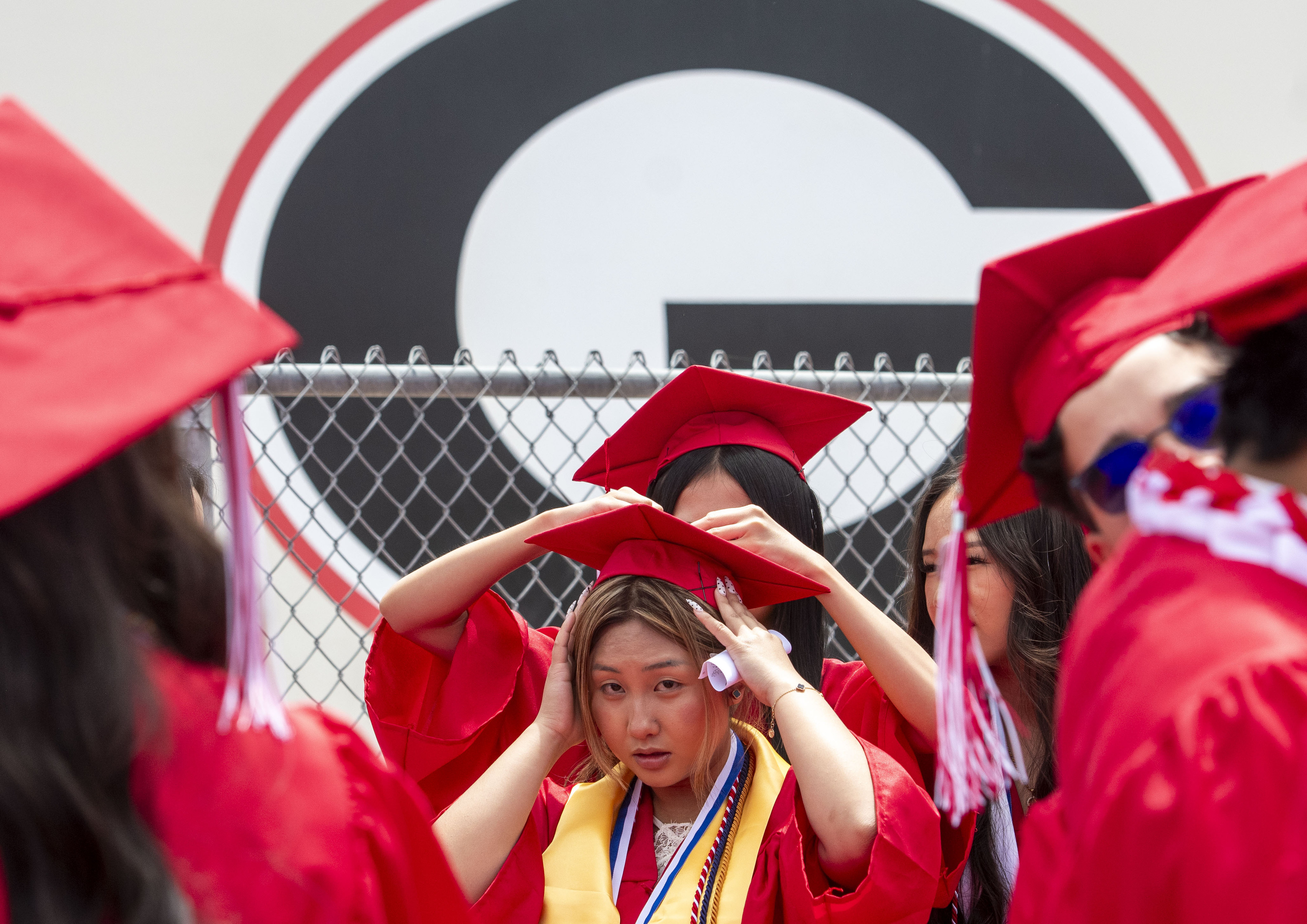 Ngan Nguyen gets her cap secured under the schoolâs big...