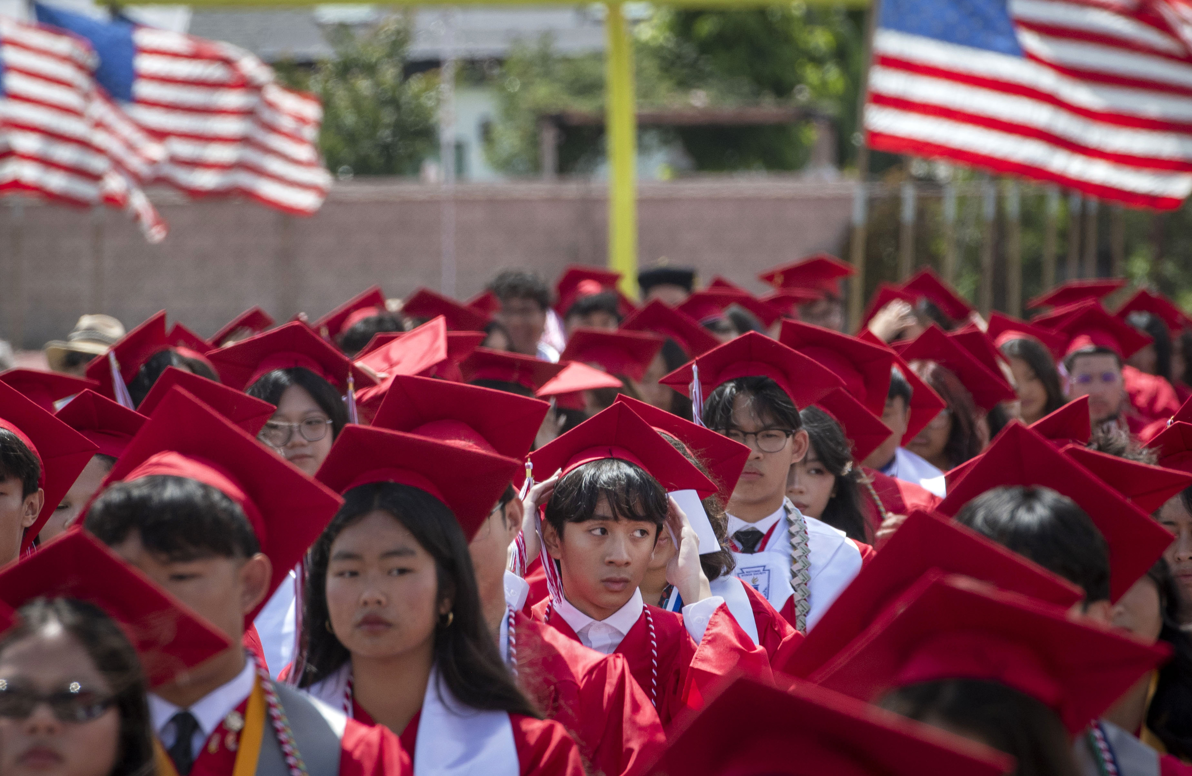 A graduate adjusts his cap during the Garden Grove High...