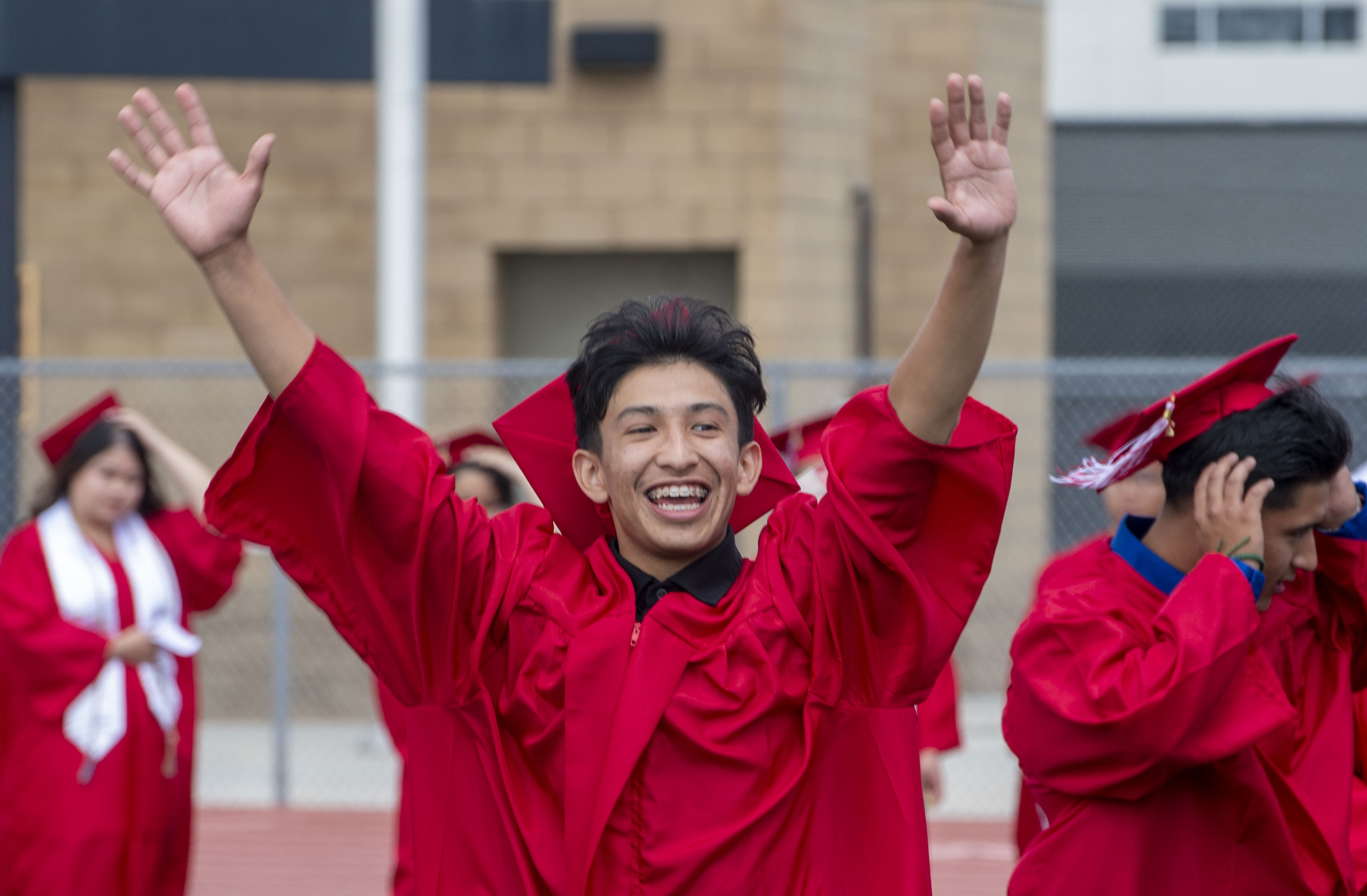 One happy grad acknowledges the crowd during the Garden Grove...