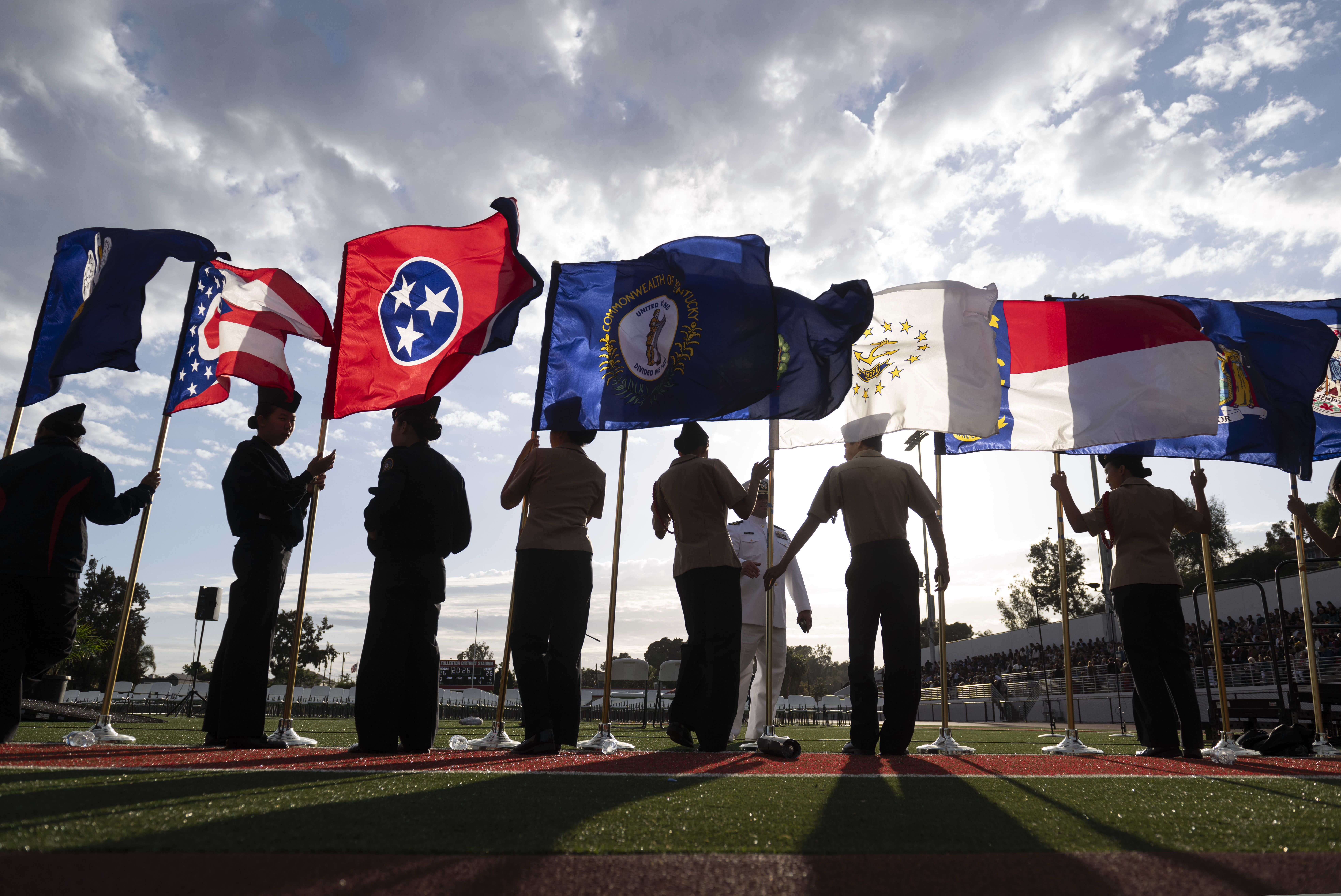 The Troy Navy JROTC cadets display the state flags at...