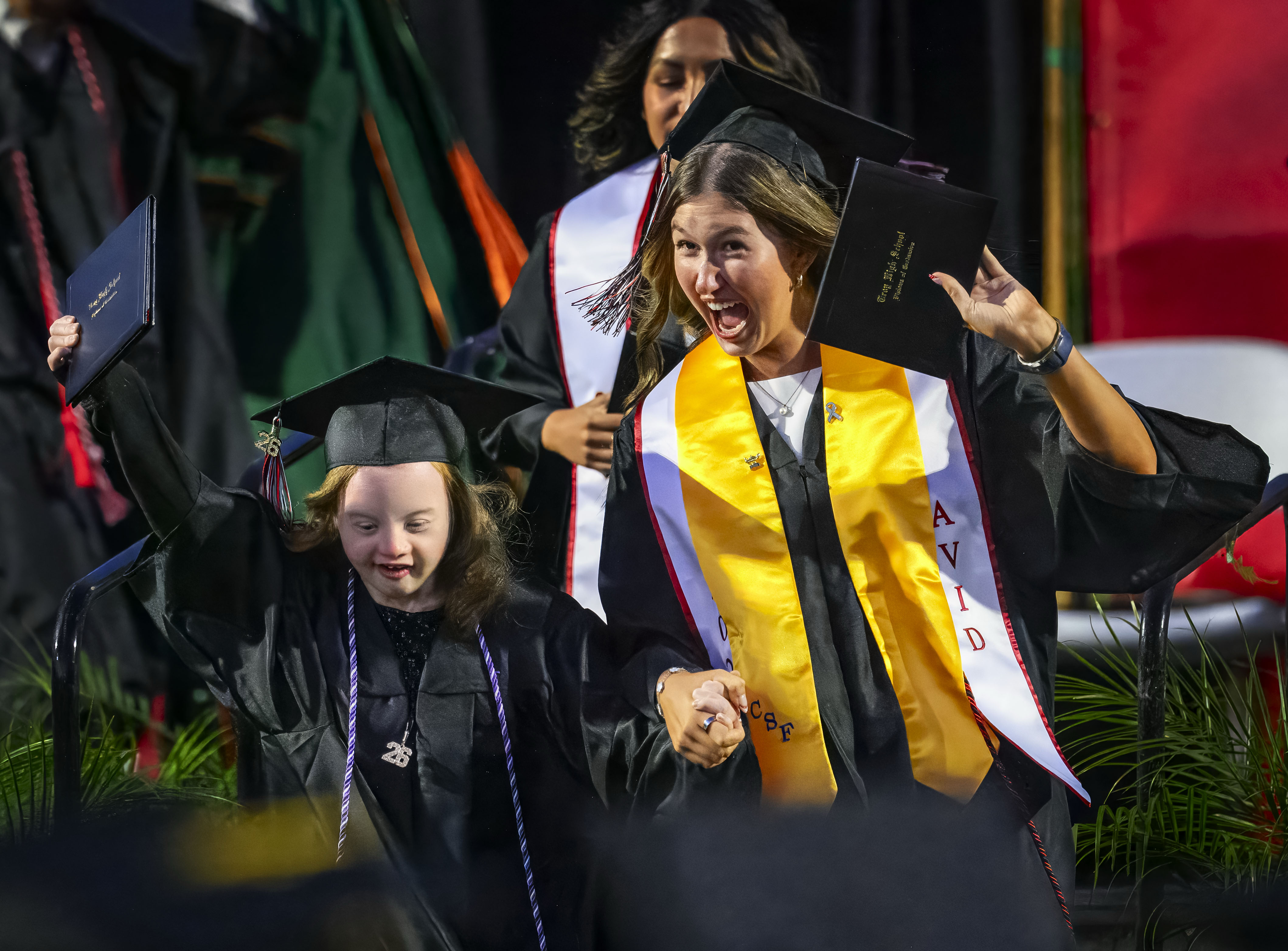 Graduates celebrate after receiving their diplomas at the Troy High...