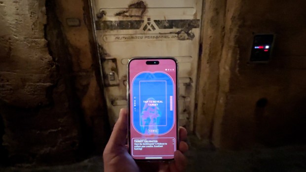The Star Wars: Batuu Bounty Hunters game on the Play Disney Parks app lets players use their smartphones to "see though" doors in Star Wars: Galaxy's Edge at Disneyland in Anaheim, CA, on Monday, October 17, 2022. (Photo by Jeff Gritchen, Orange County Register/SCNG)