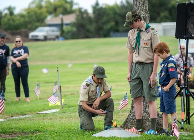 A group of Boy Scouts, from Orange County Troops 106 and 711, light The Eternal Flame during the Memorial Day Ceremony at Harbor Lawn- Mt. Olive Memorial Park in Costa Mesa on Monday, May 27, 2024.