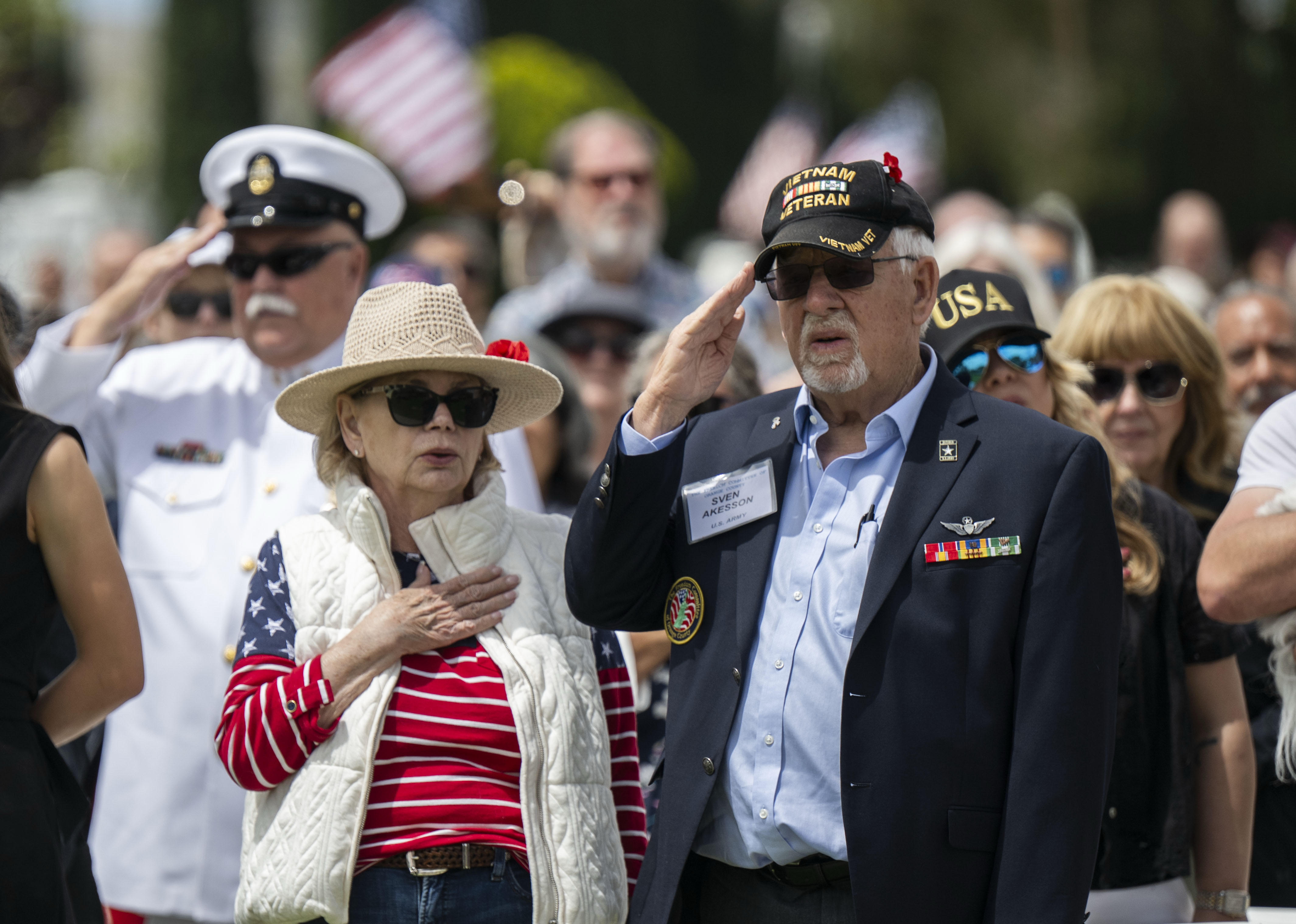 Army veteran Sven Akisson salutes during the National Anthem during...
