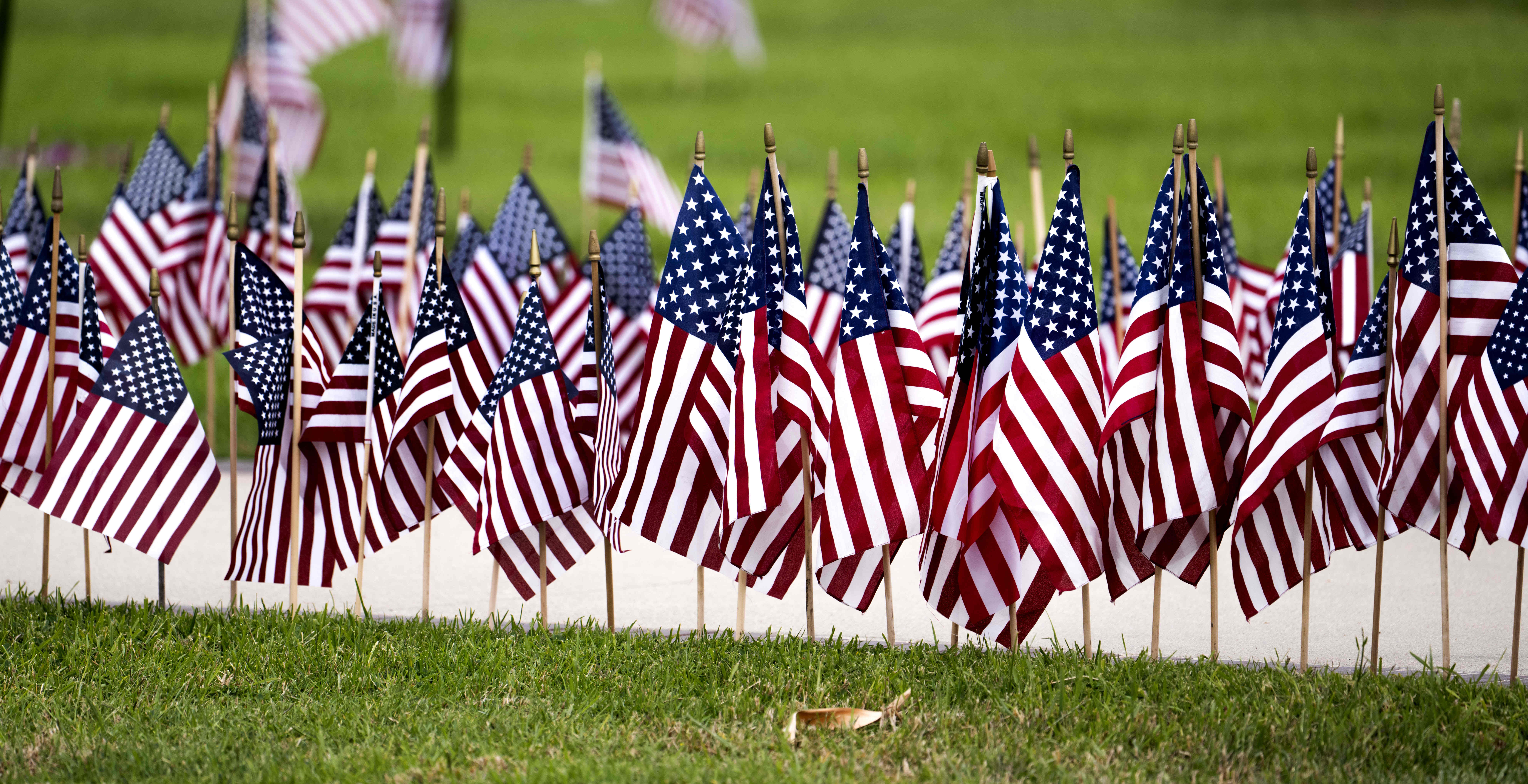 Flags line the walkway to the Memorial Day ceremony at...